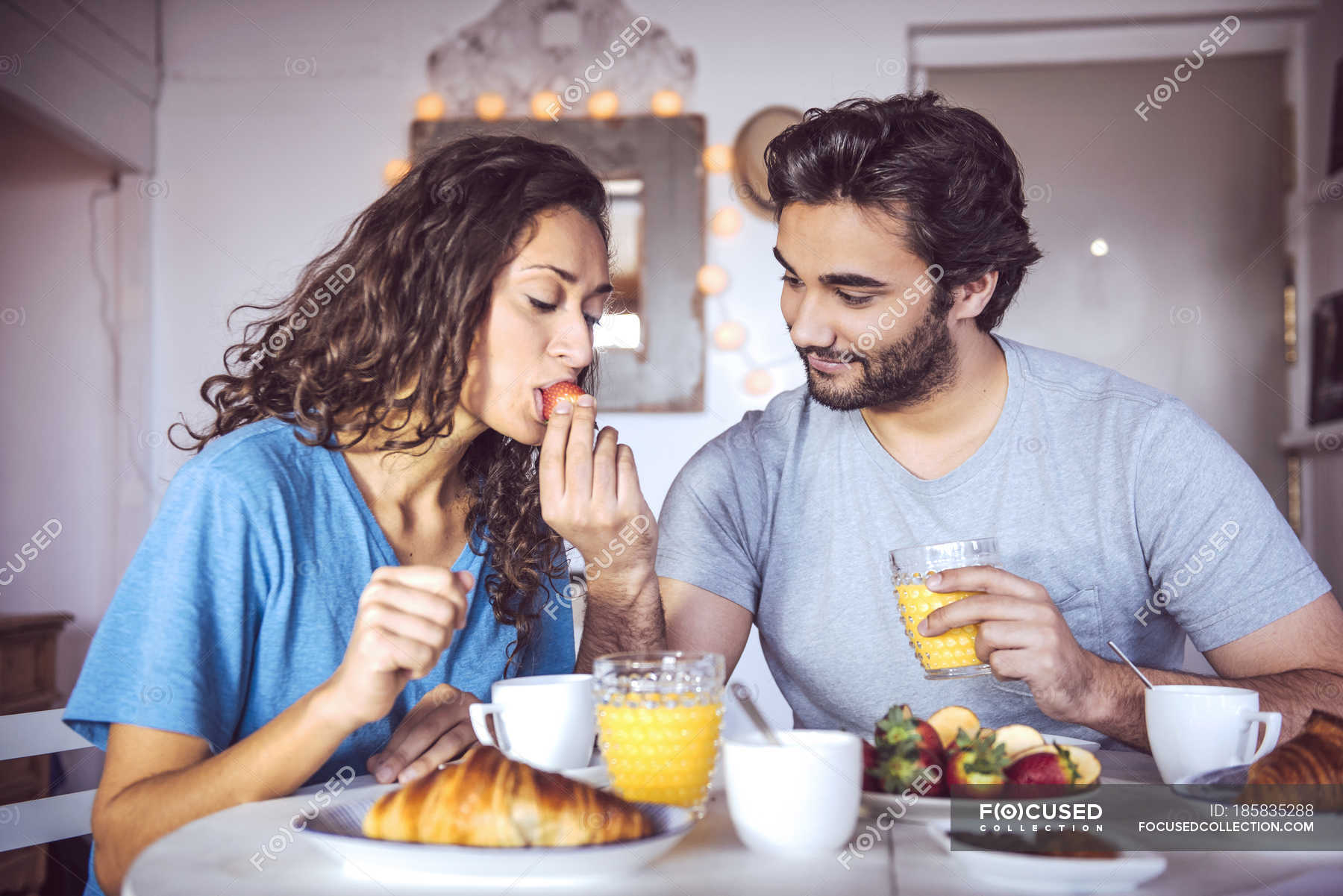 Young Man Feeding Girlfriend At Breakfast Morning Grapefruit Stock 