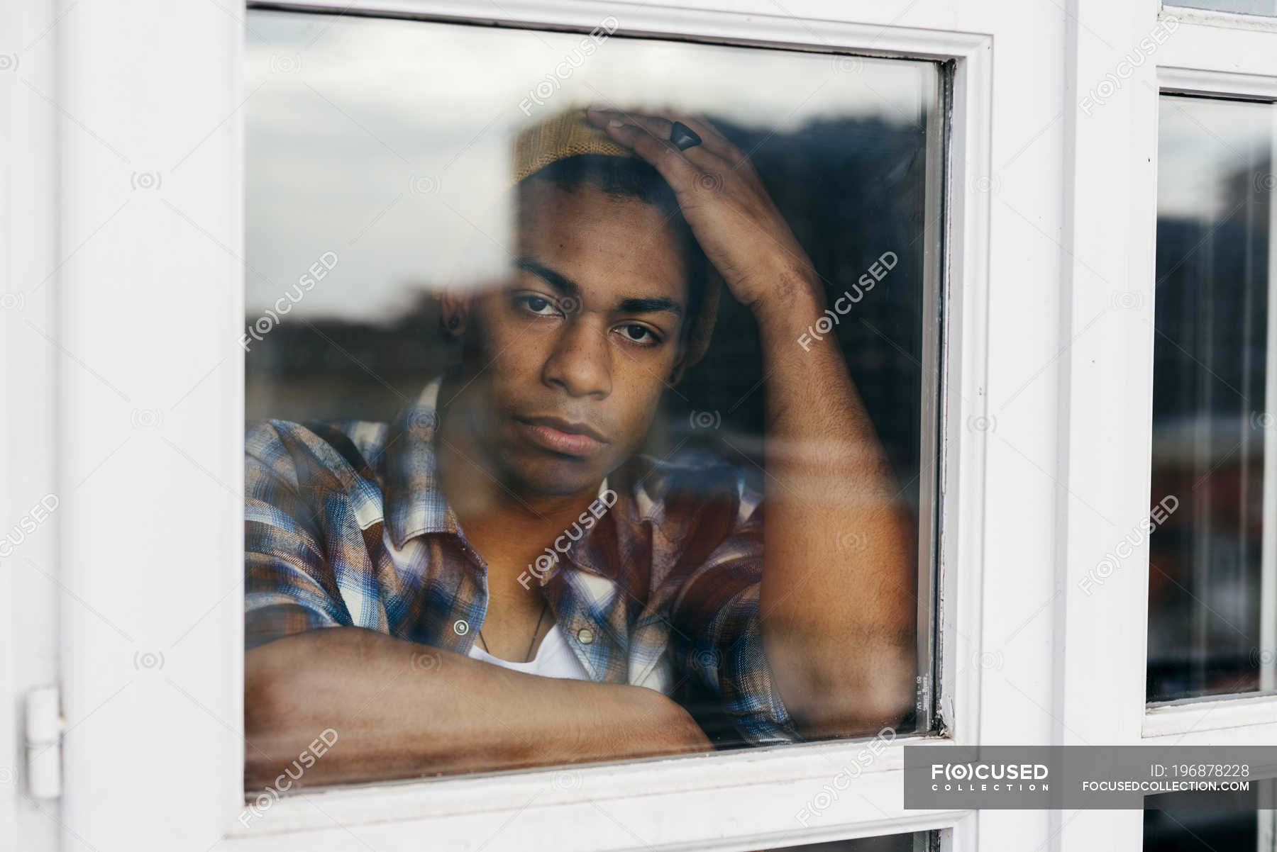 Premium Photo  Unrecognizable young man stands by the window