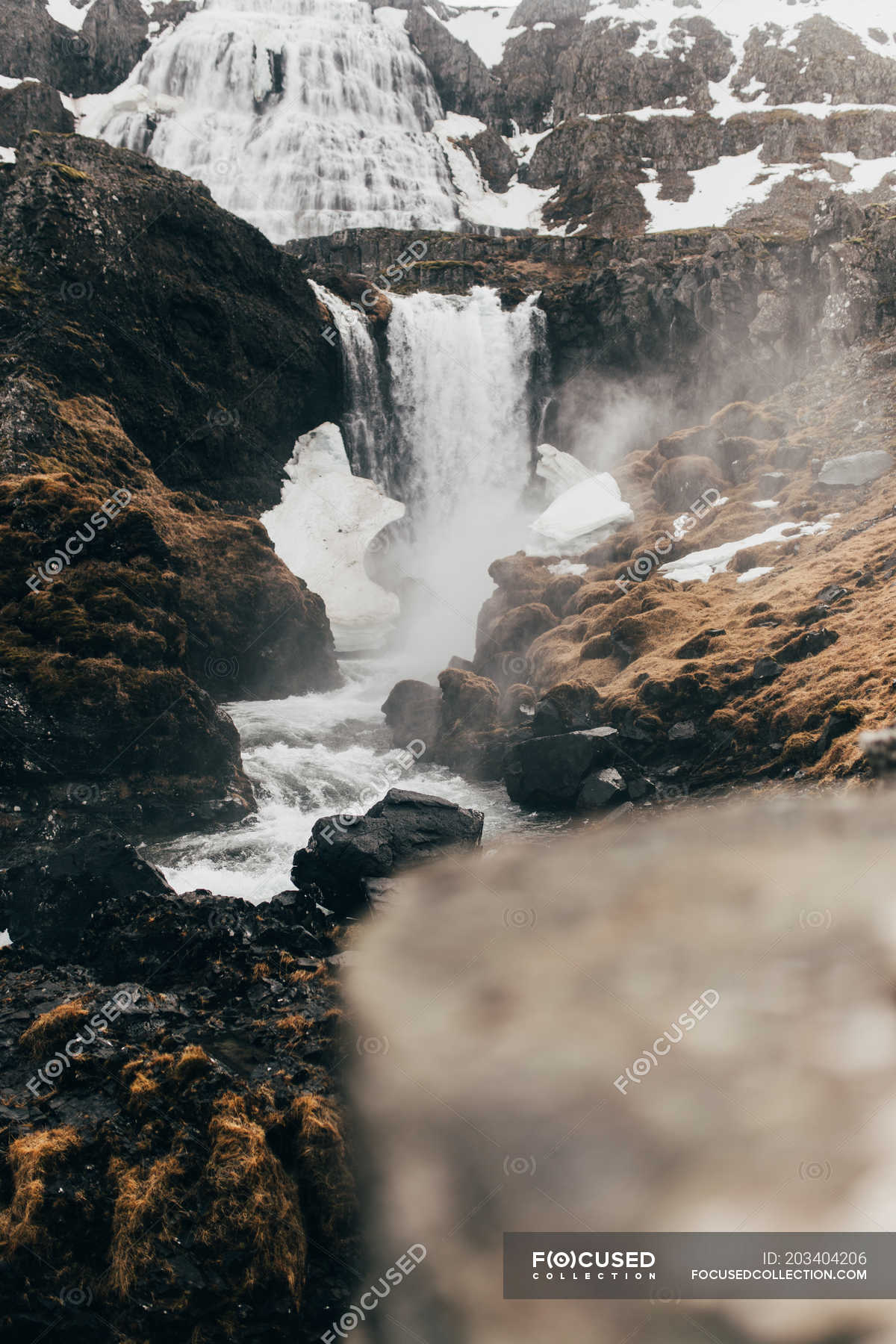 Waterfall flowing from gloomy black rocks — falling, iceland - Stock ...