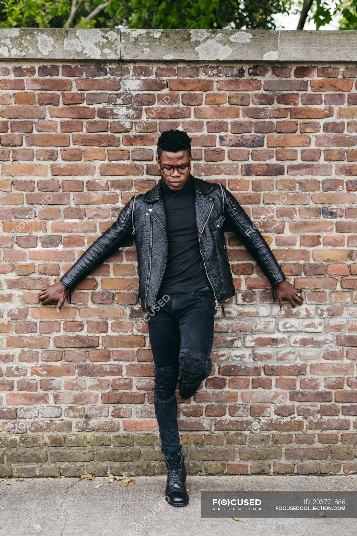 Man posing against brick wall — On One Leg, urban - Stock Photo ...