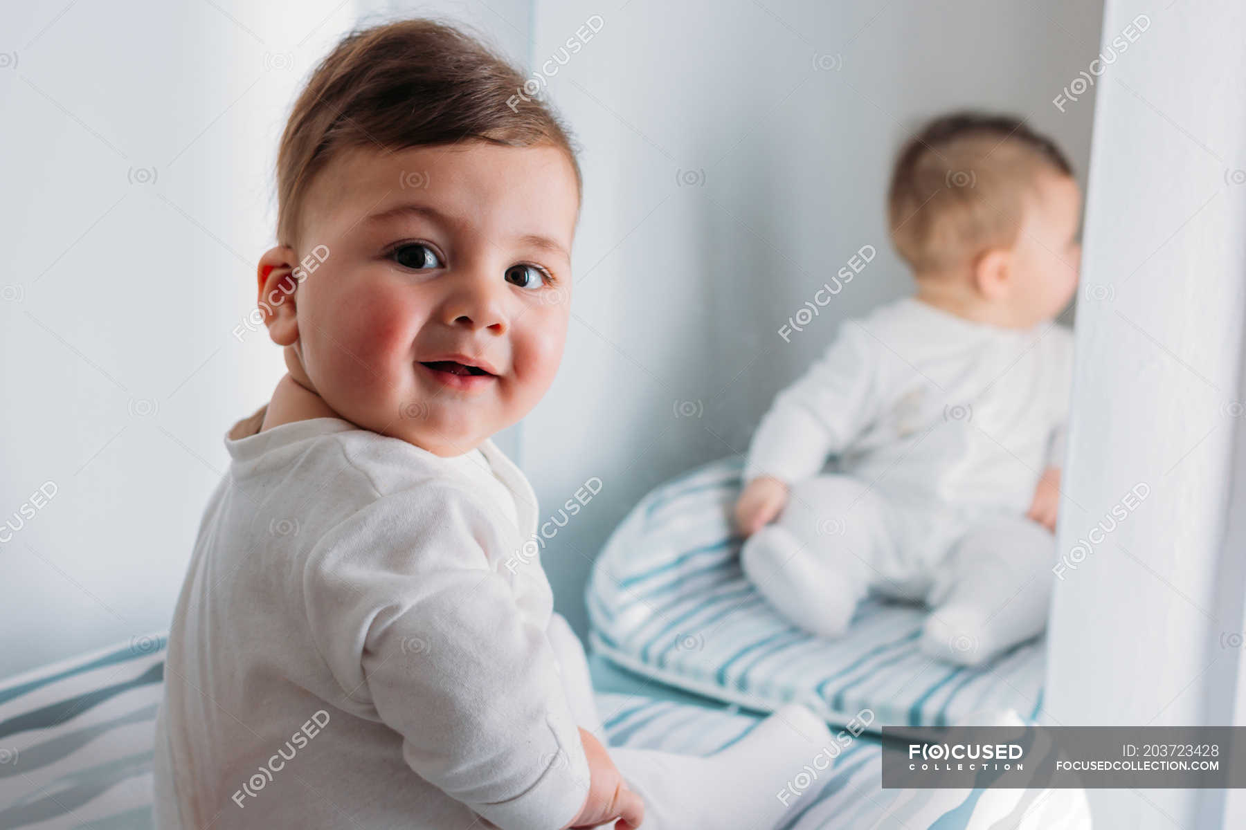 Baby in front outlet of mirror