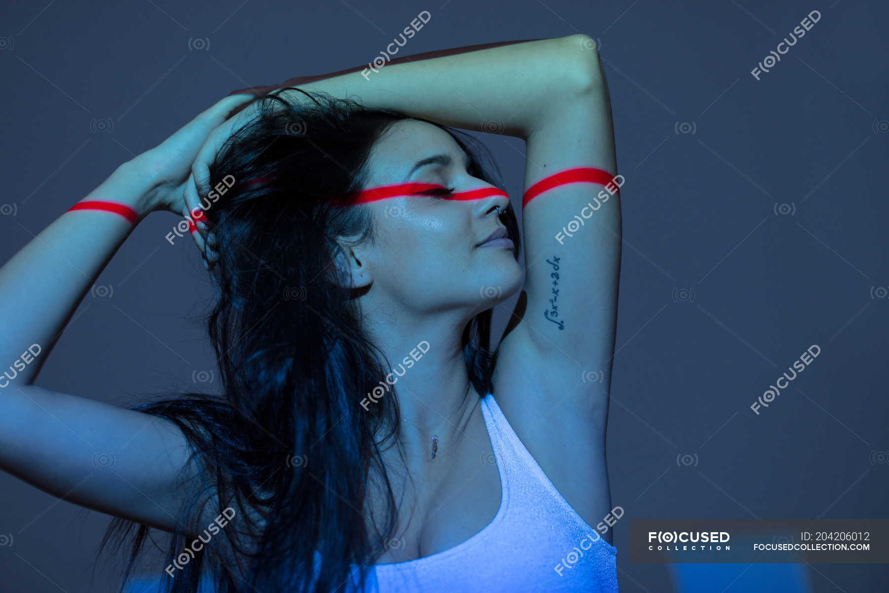 young-attractive-woman-with-red-line-on-face-and-arms-on-dark