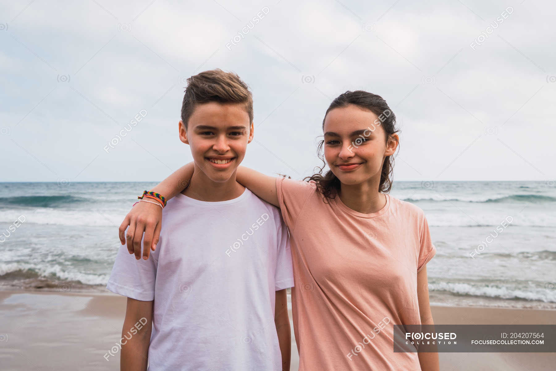Portrait Of Smiling Teen Girl And Boy Standing On Beach Female Daytime Stock Photo 204207564