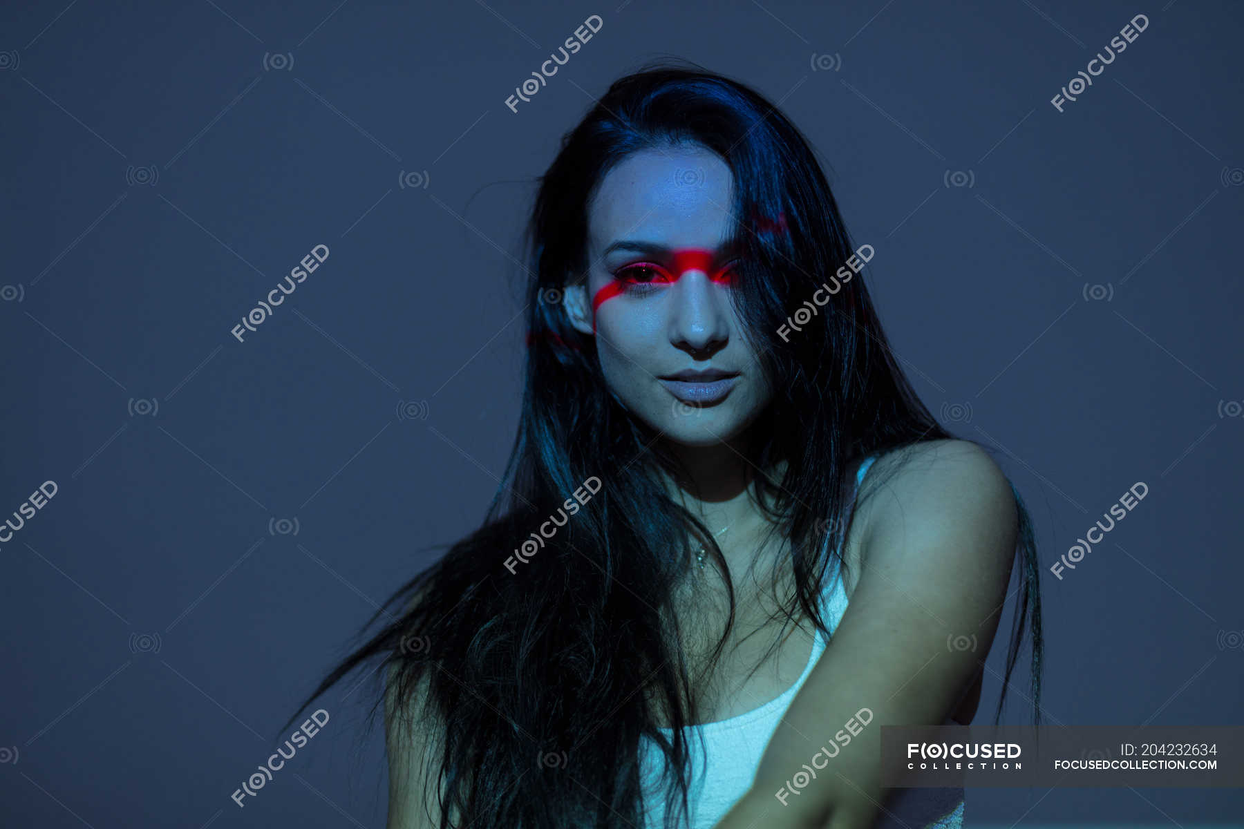 young-attractive-woman-with-red-line-on-face-standing-on-grey