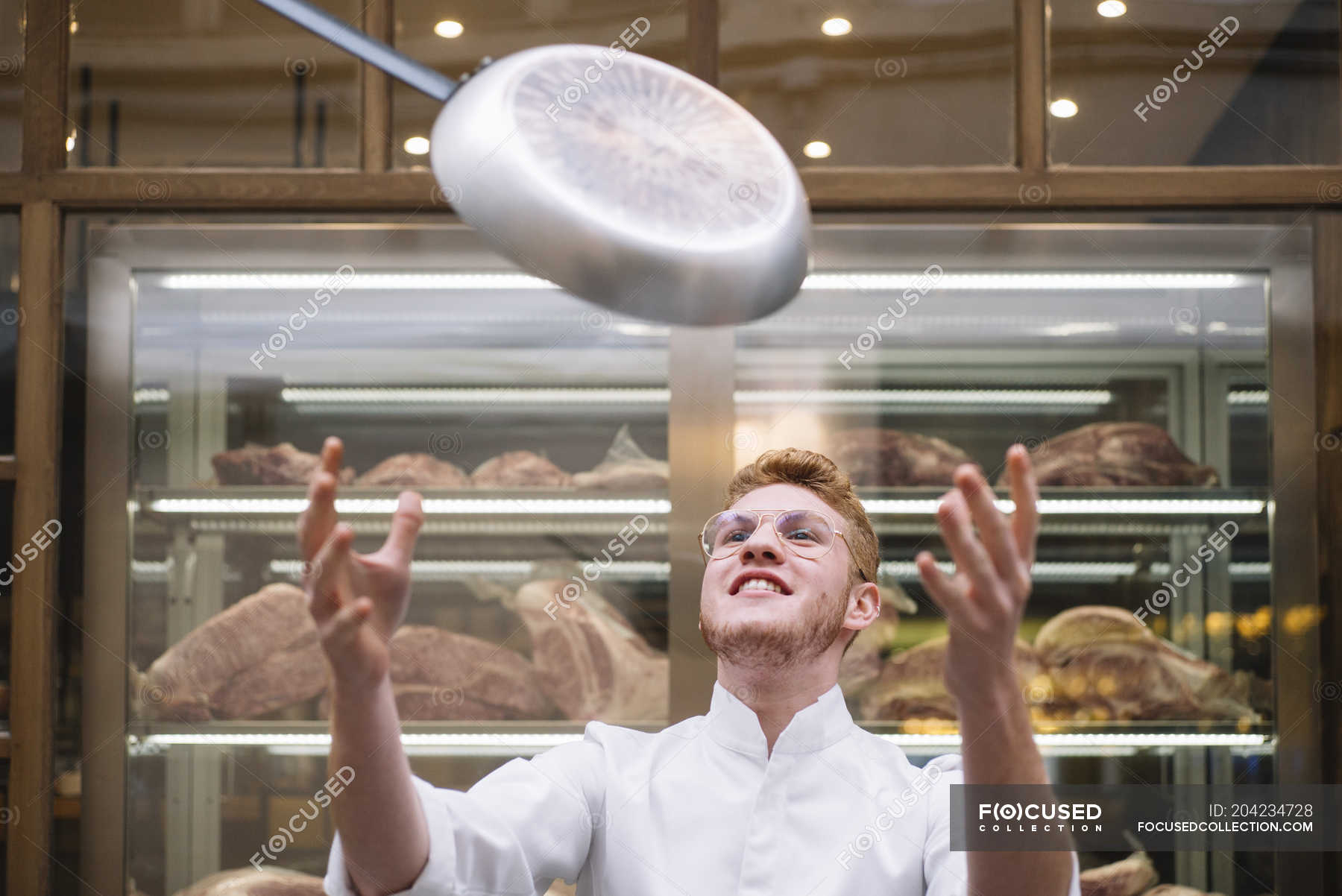 Chef cook throwing up frying pan in restaurant — occupation, people