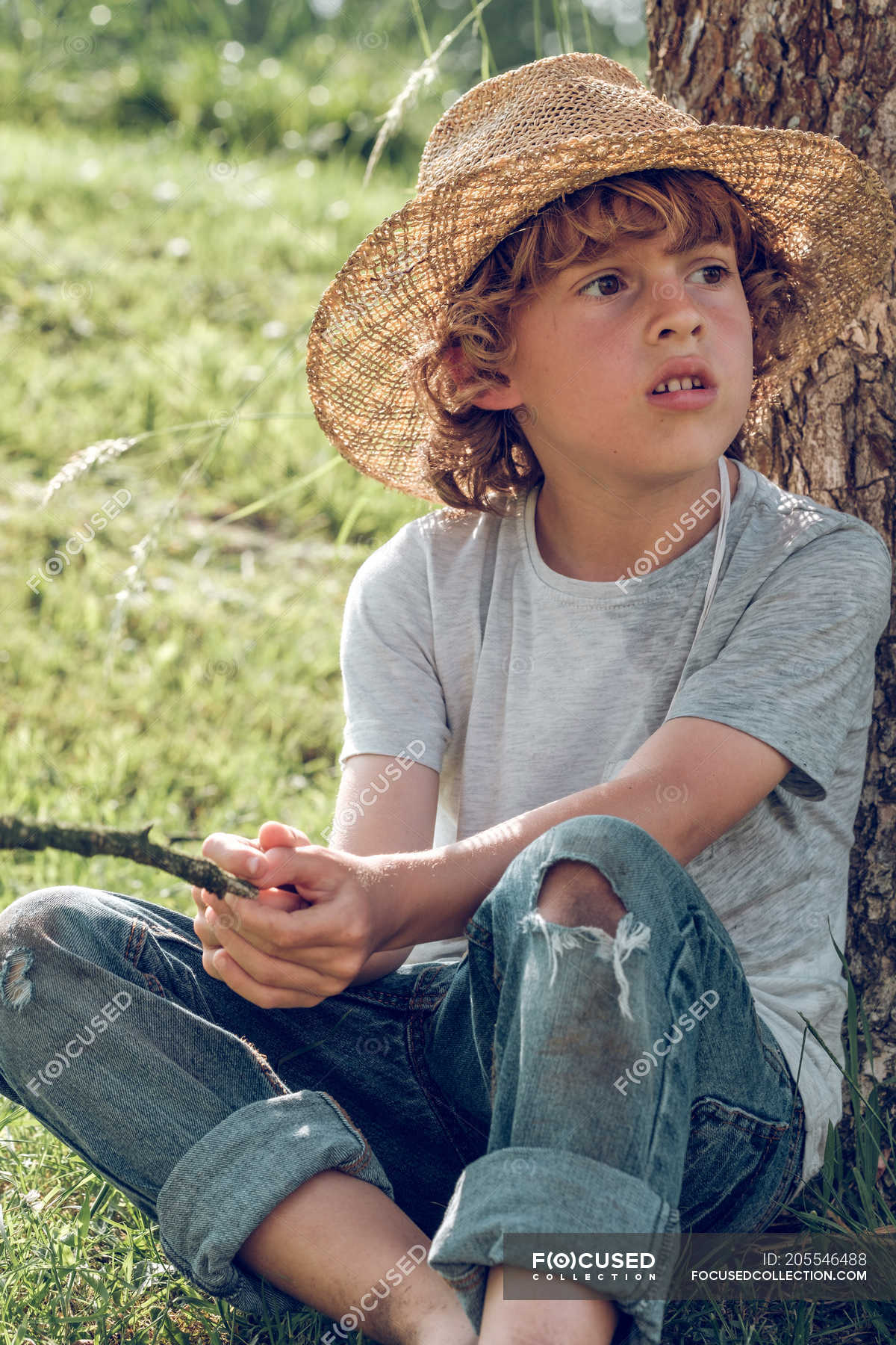 Barefoot Boy Sitting On A Rock