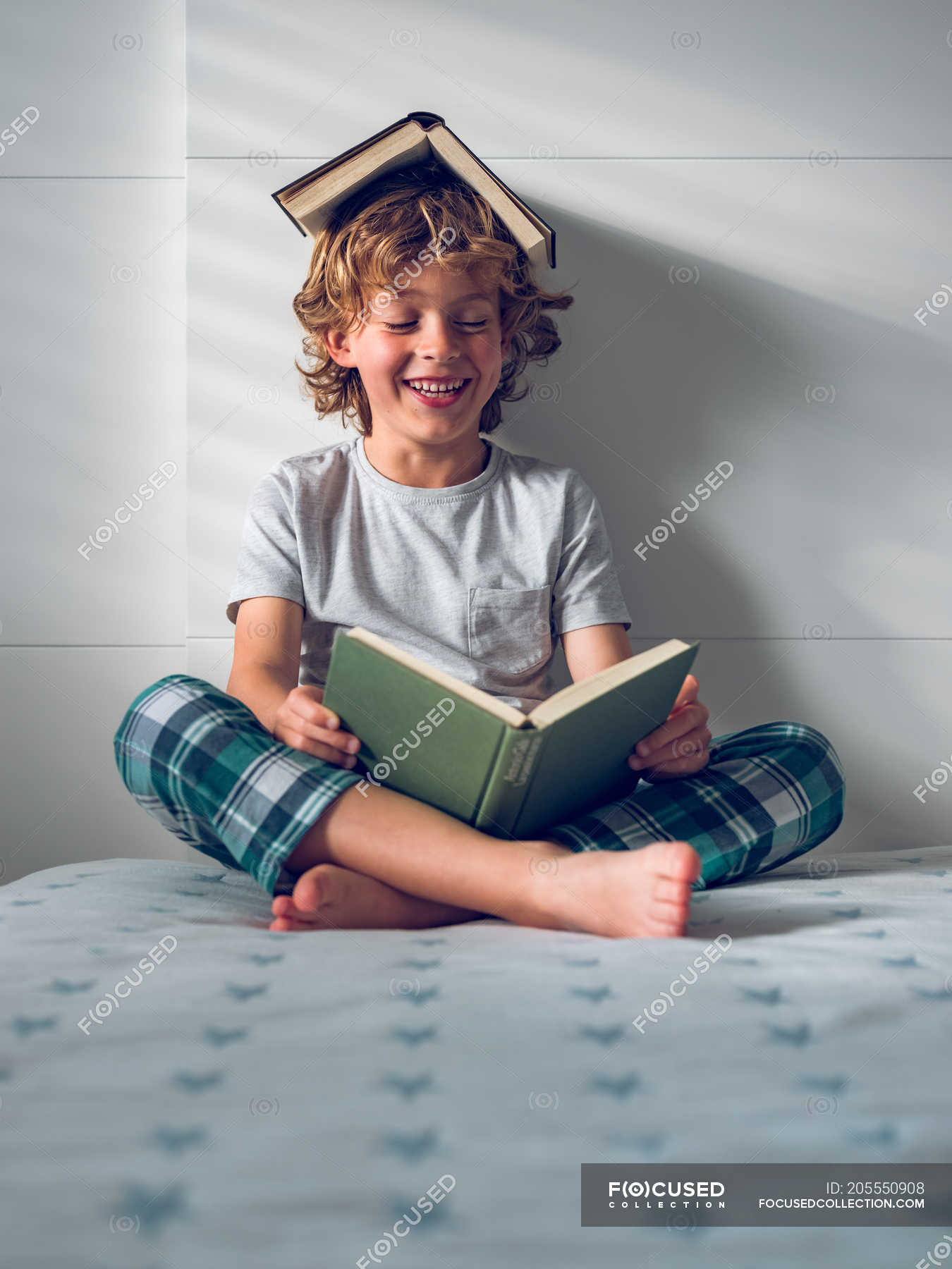 Funny boy reading book — sitting, calm - Stock Photo | #205550908