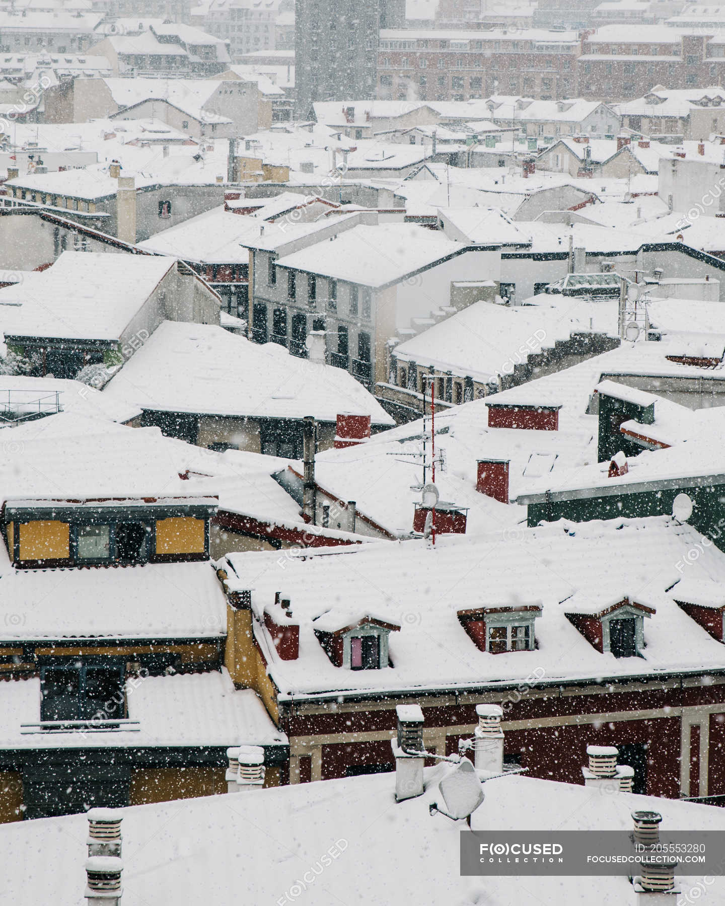 Aerial view of snowy roofs of houses in Bilbao, Spain. — season, white