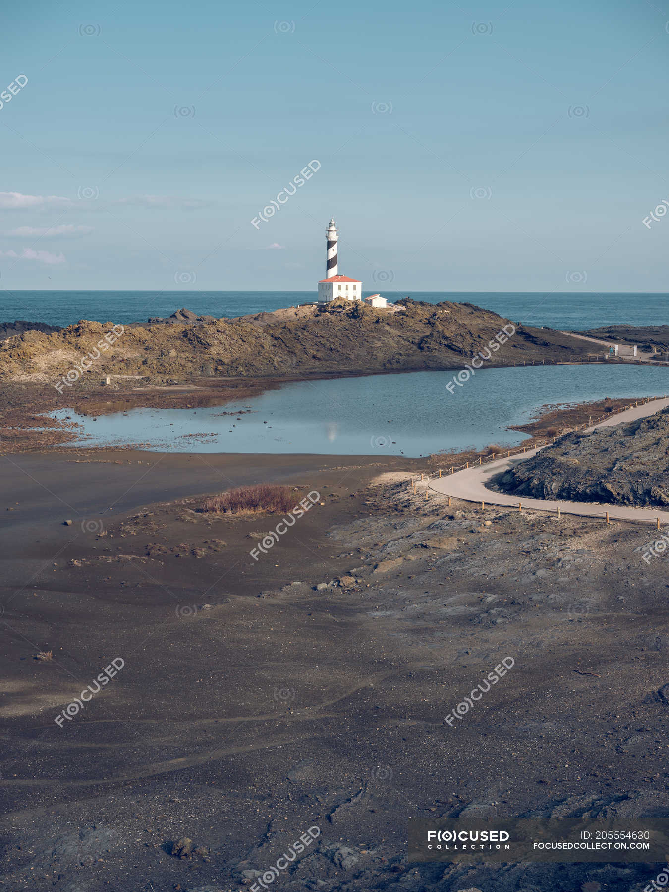 Rocky coast and beacon tower — seashore, spain - Stock Photo | #205554630