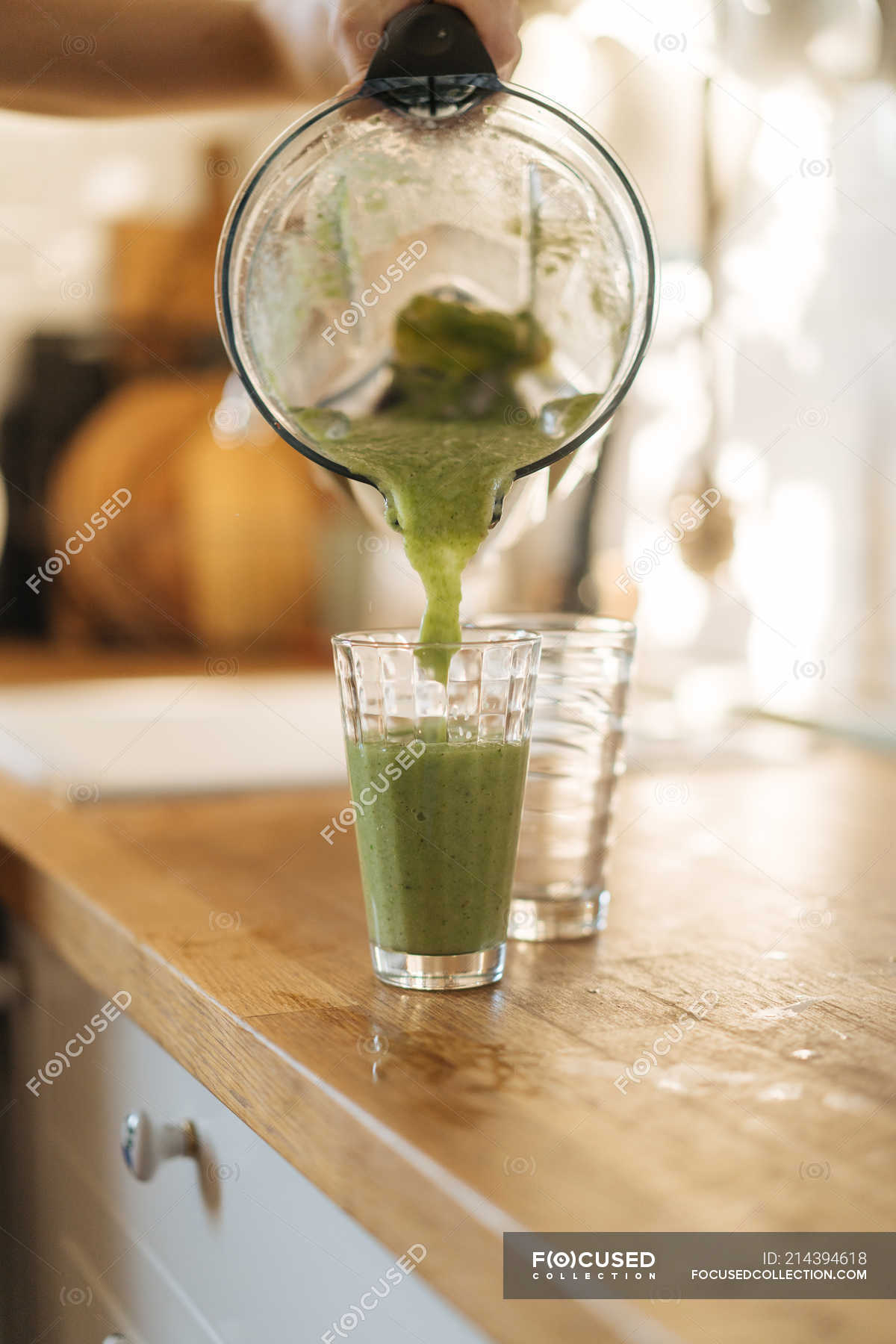 Human hand pouring smoothie in glass — natural, recipe - Stock Photo |  #214394618