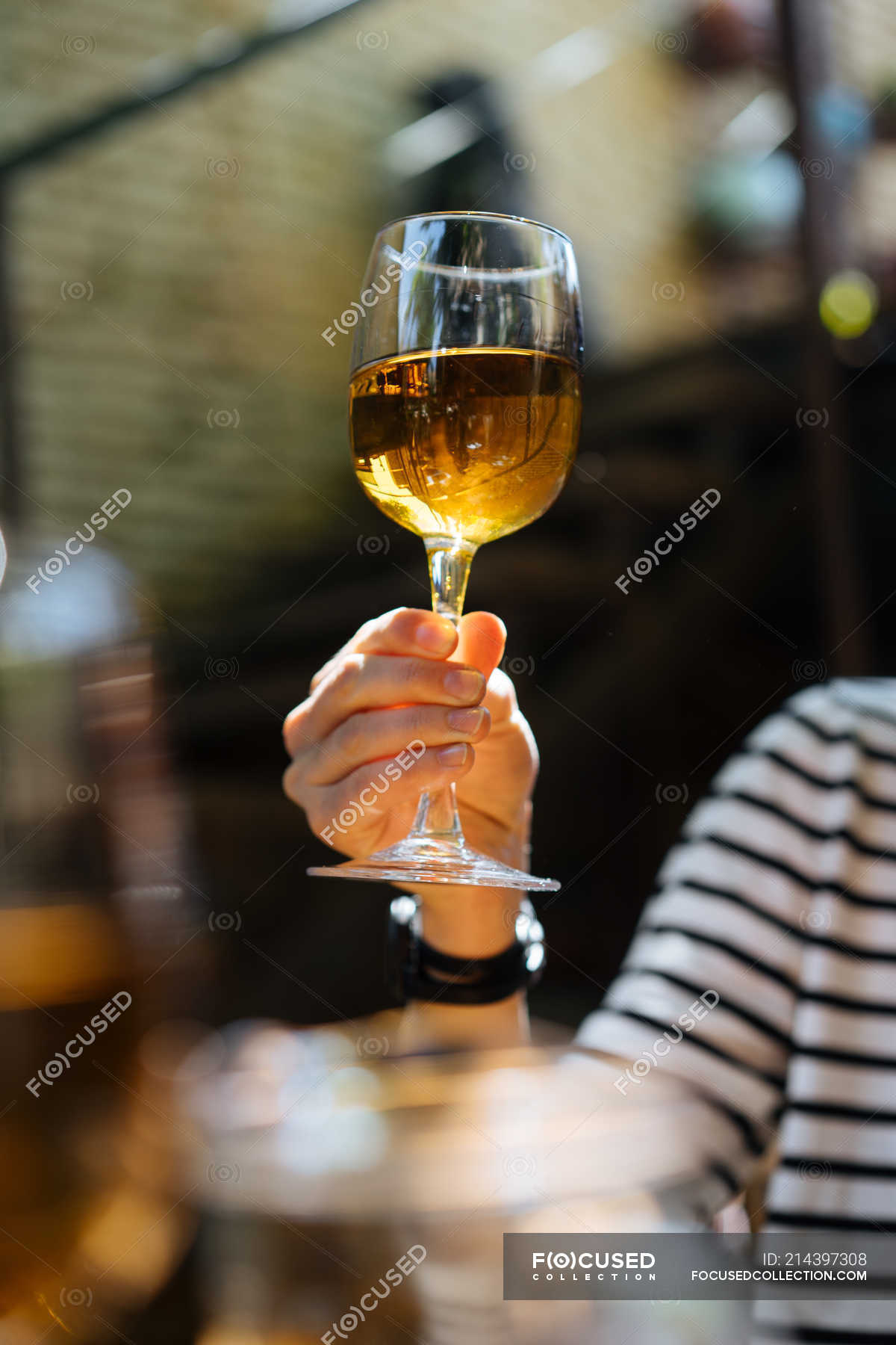 close-up-of-female-hand-holding-glass-of-white-wine-selective-focus