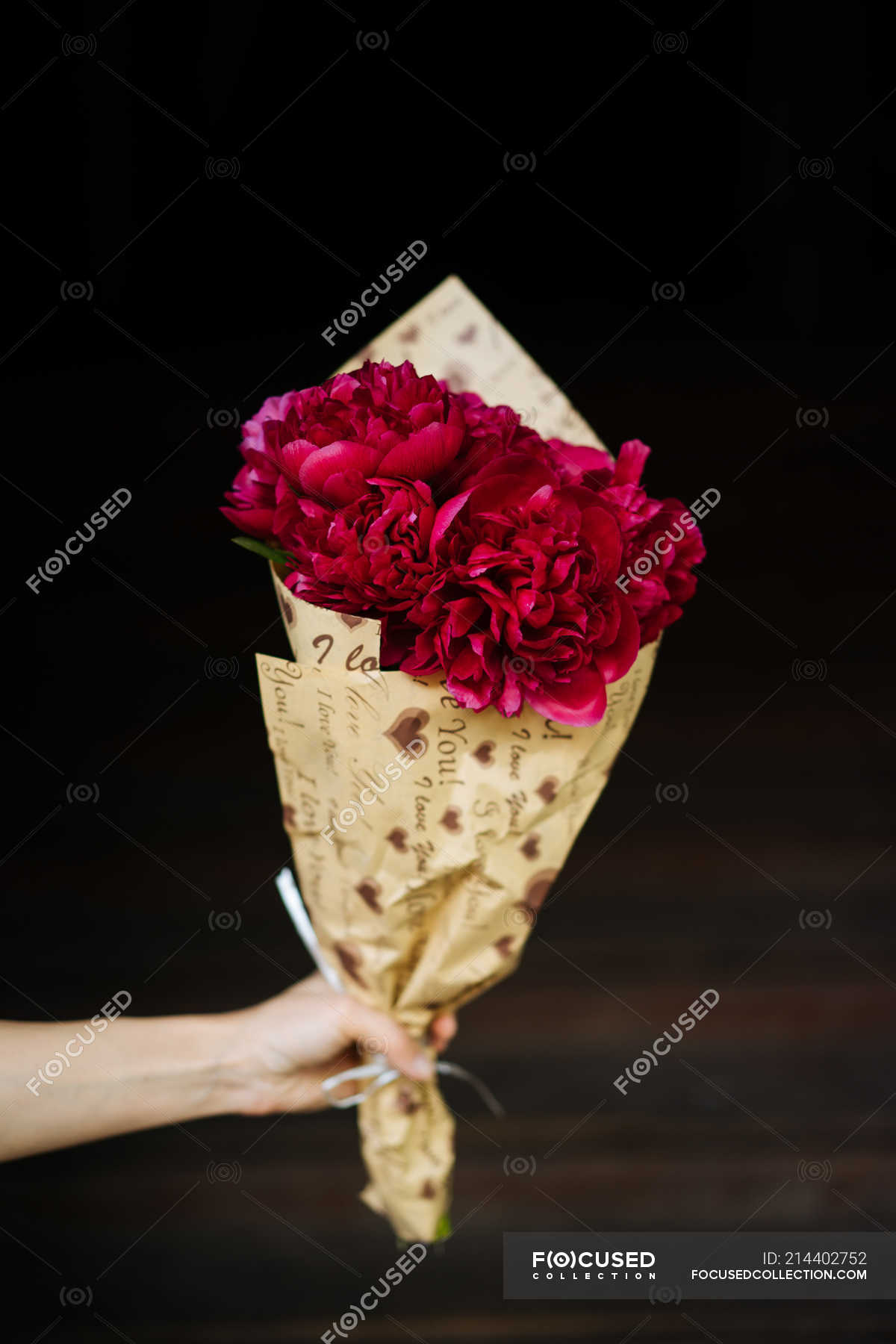 A Person Holding Peony Flowers in a Brown Paper Bag · Free Stock Photo