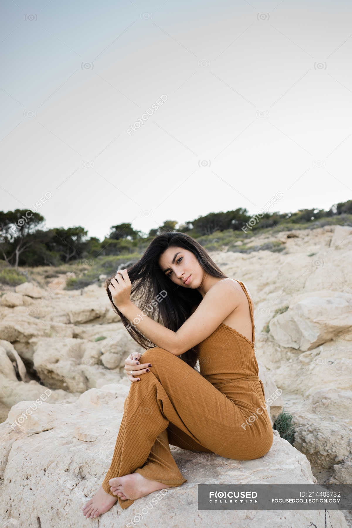 https://st.focusedcollection.com/9163412/i/1800/focused_214403732-stock-photo-stylish-young-woman-sitting-rocks.jpg