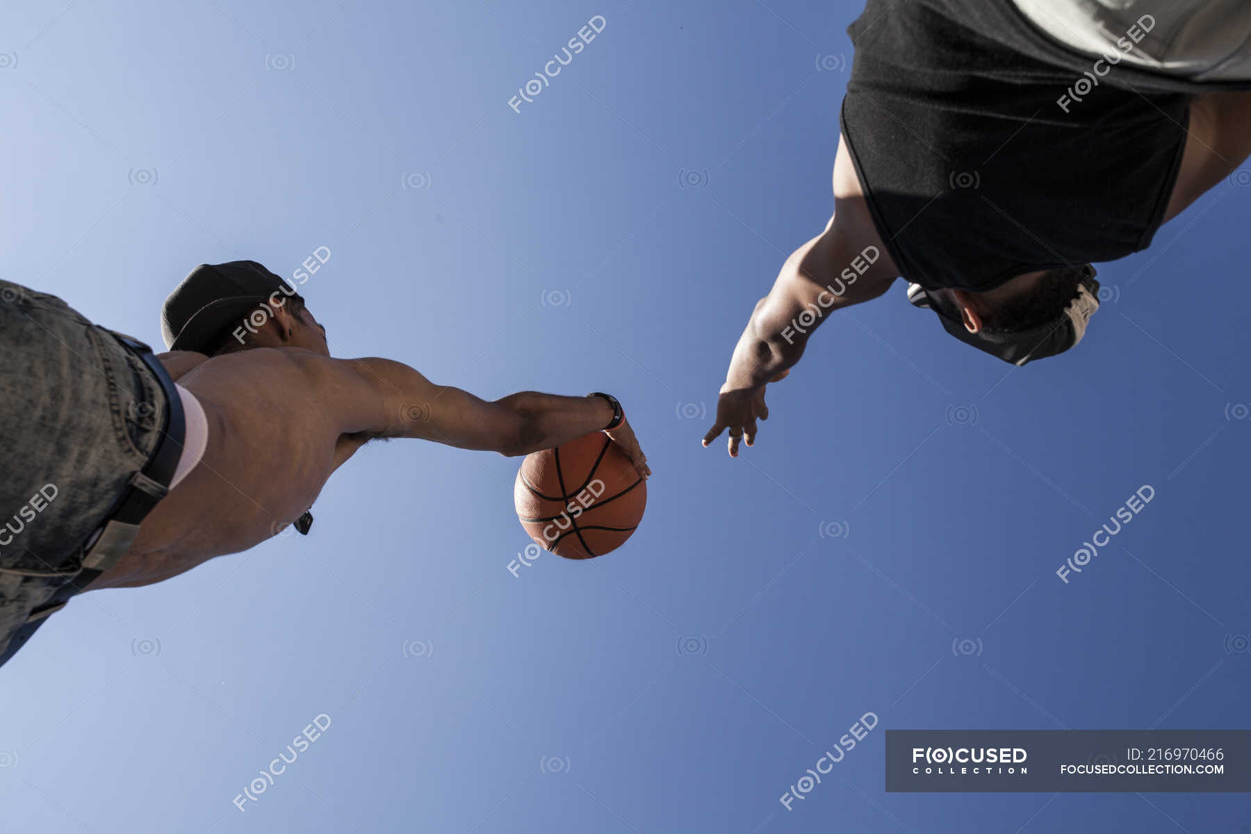 Young brothers playing basketball against blue sky — Hispanic, portrait ...