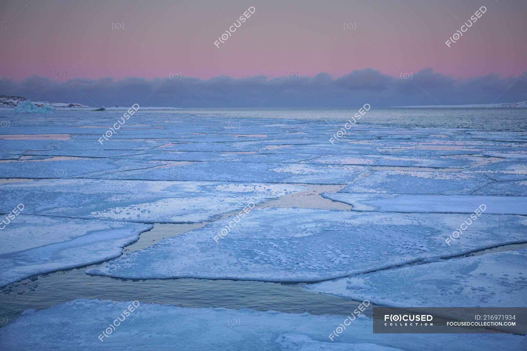 Big blocks of ice floating on surface of water in spring evening