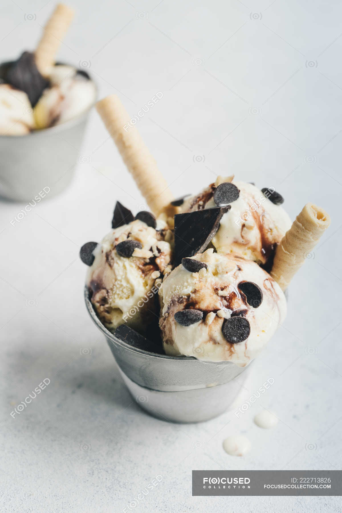 Vanilla Ice Cream With Chocolate And Wafers On White Surface