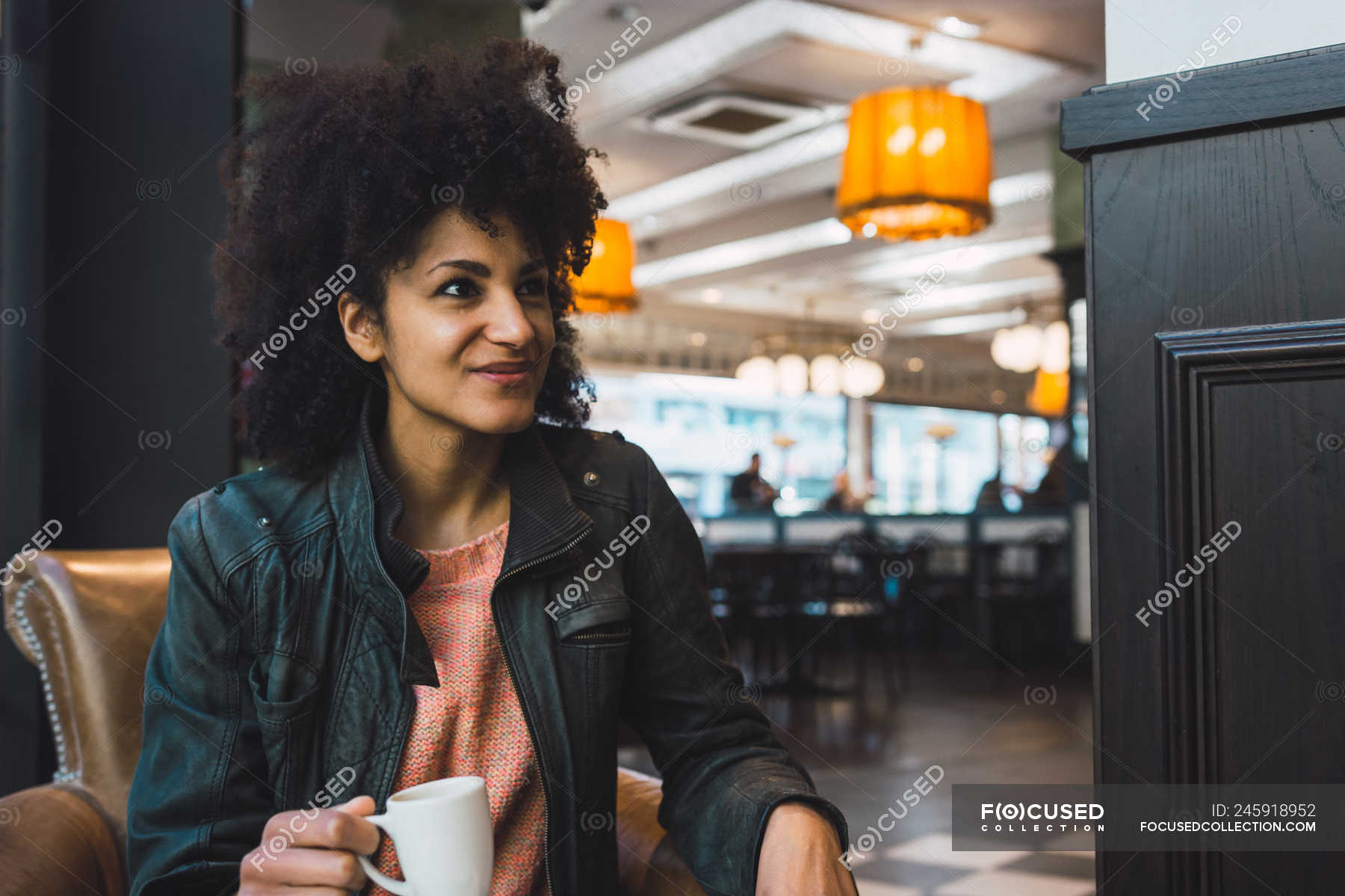 Black woman with afro hair drinking a coffee in a coffee shop — young ...