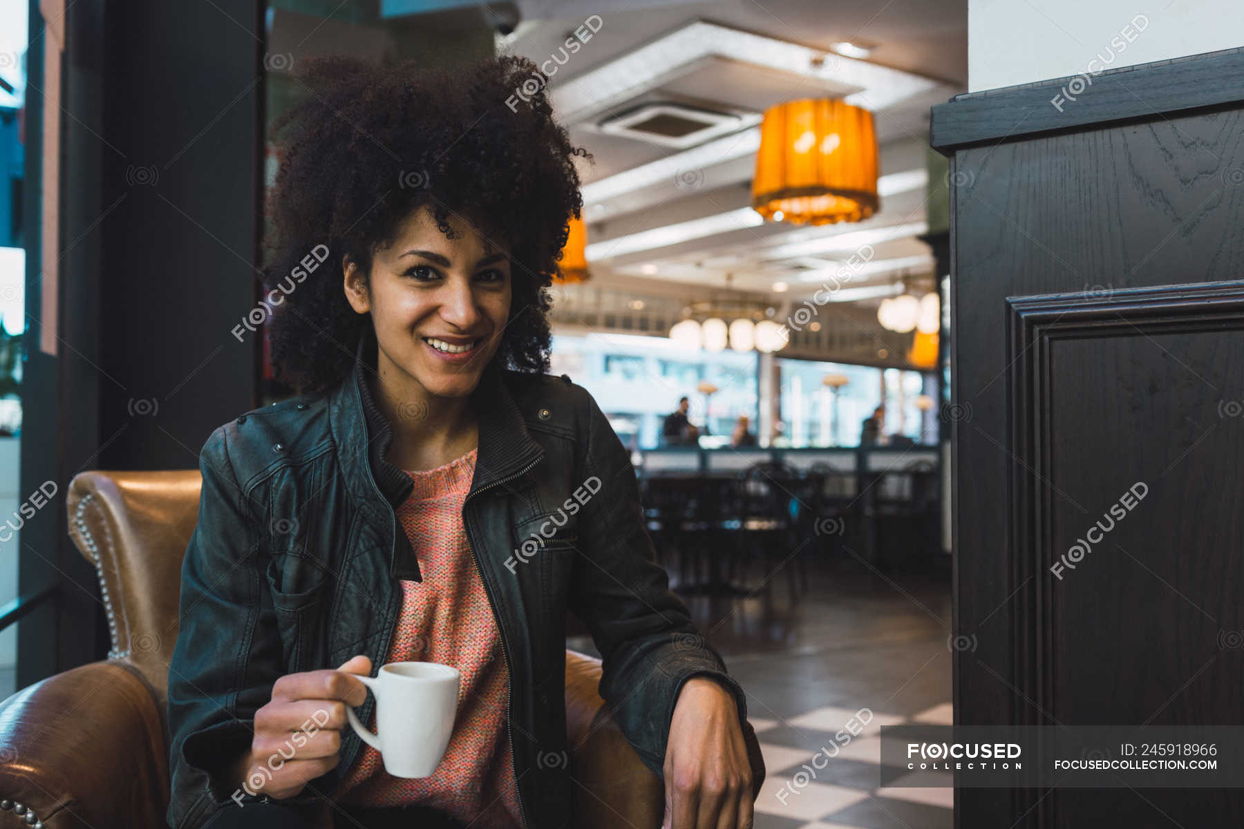 Black woman with afro hair drinking a coffee in a coffee shop — female ...