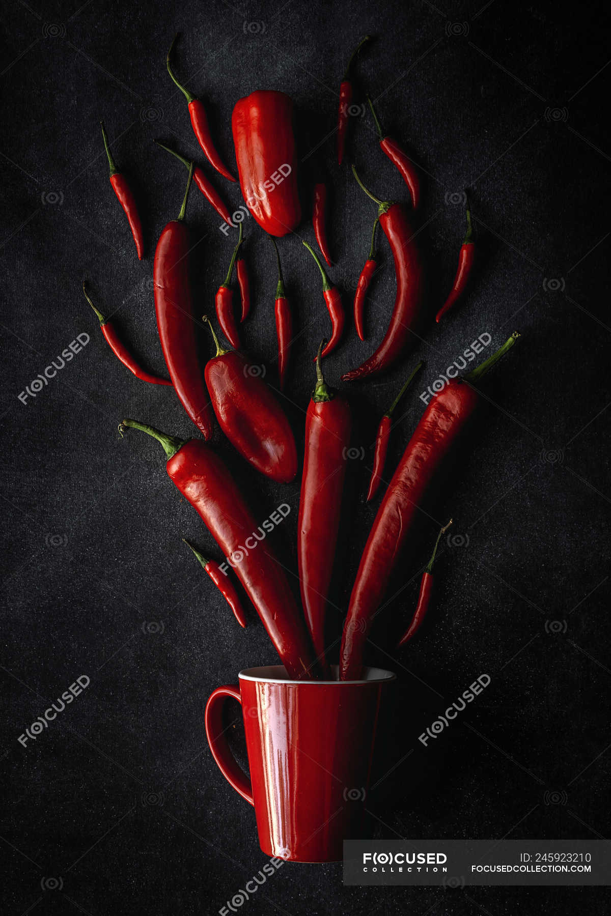 Fresh red spicy chilli peppers and mug on black background — healthy food,  eco - Stock Photo | #245923210