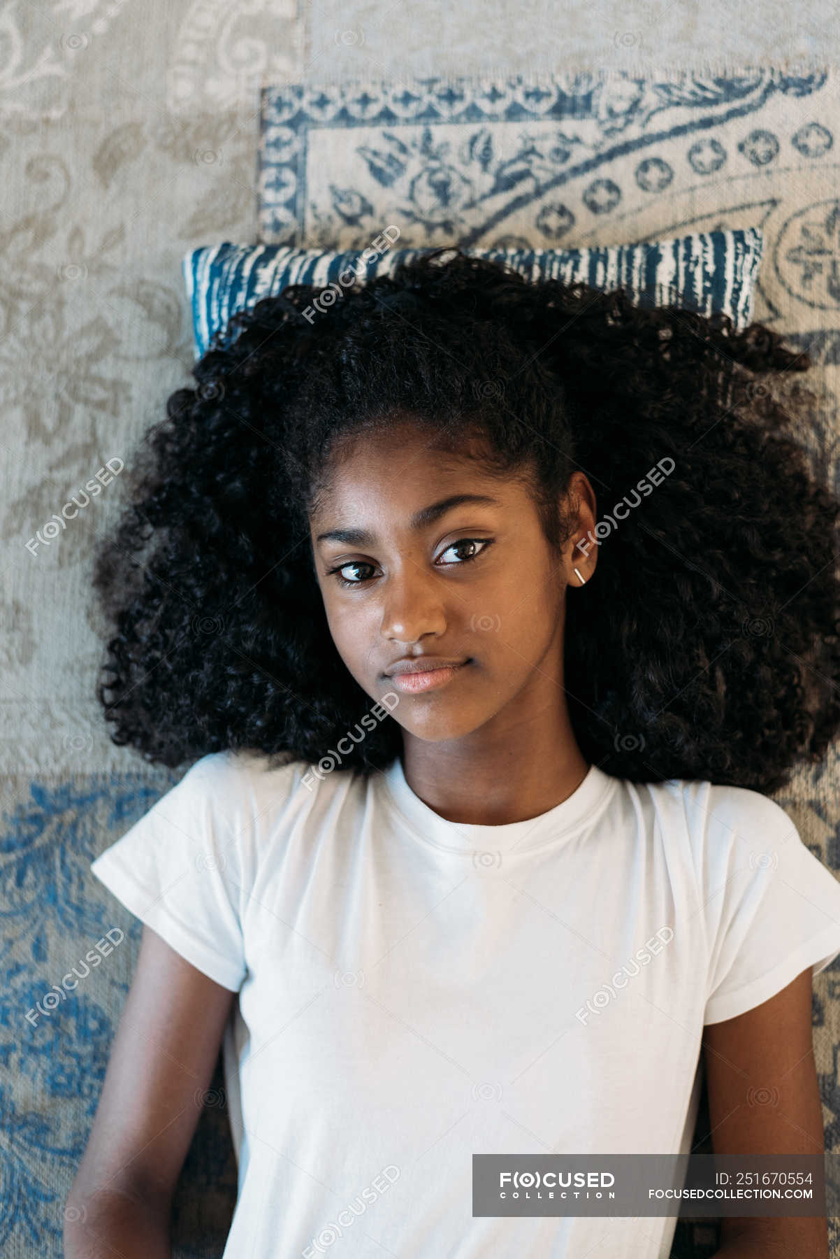 Young black teenage girl lying down in 