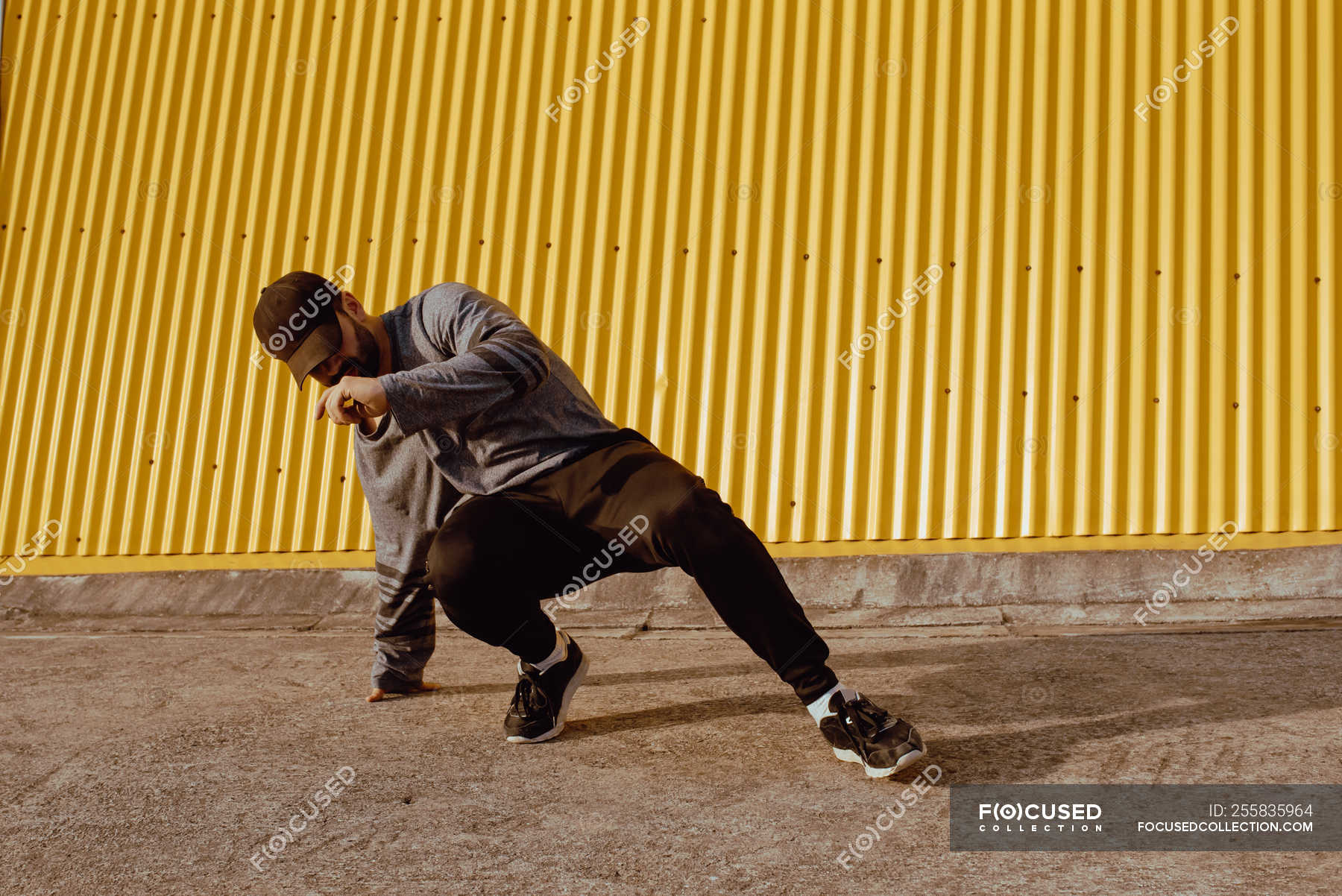 guy-performing-dancing-near-wall-of-modern-building-on-city-street