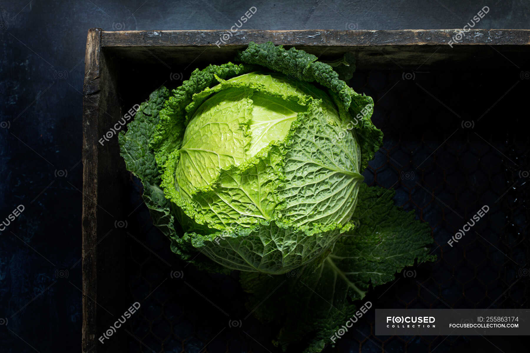 From above green head of savoy cabbage in wooden box — kitchen ...