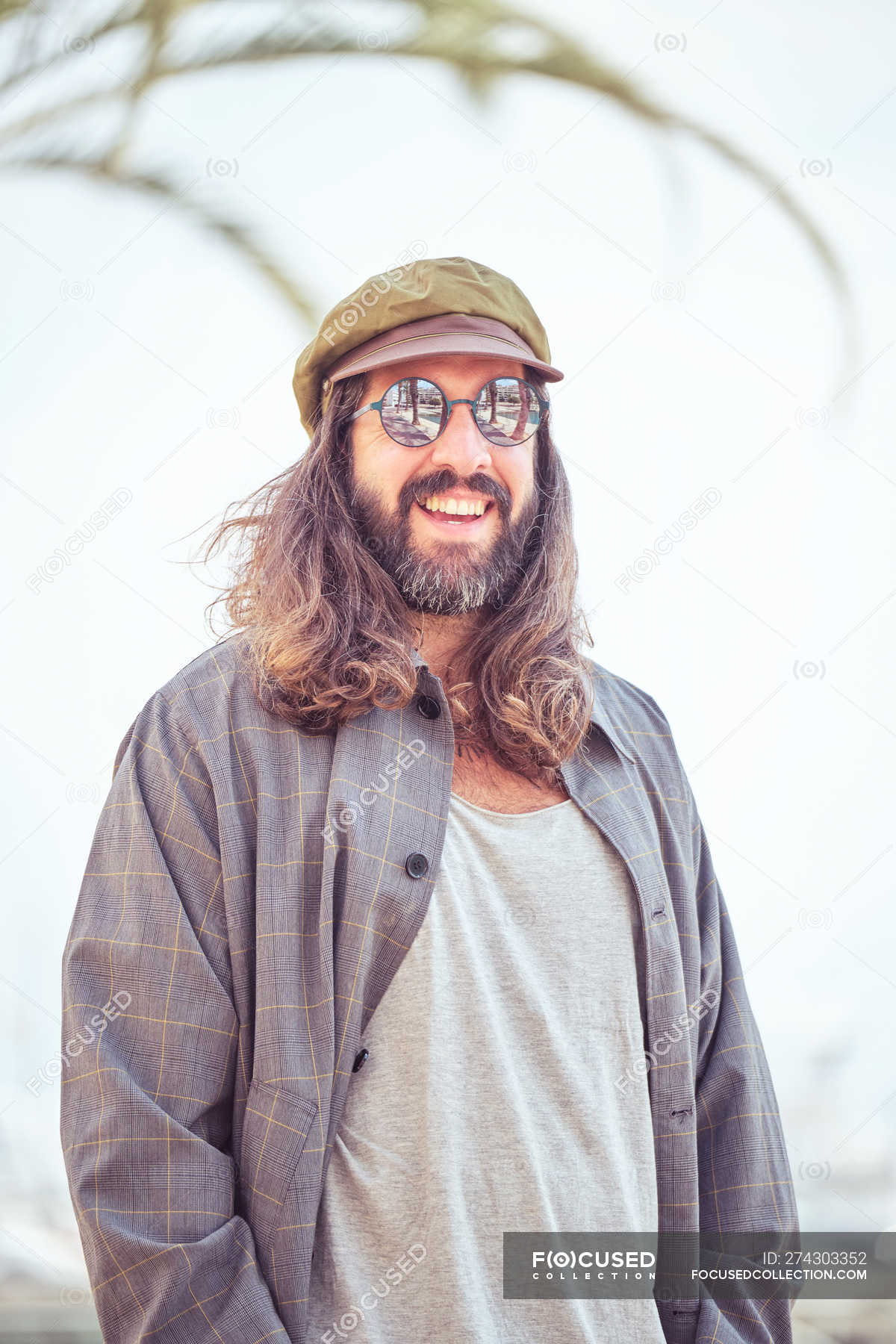 Stylish smiling bearded man with long hair posing on street — handsome,  hipster - Stock Photo | #274303352