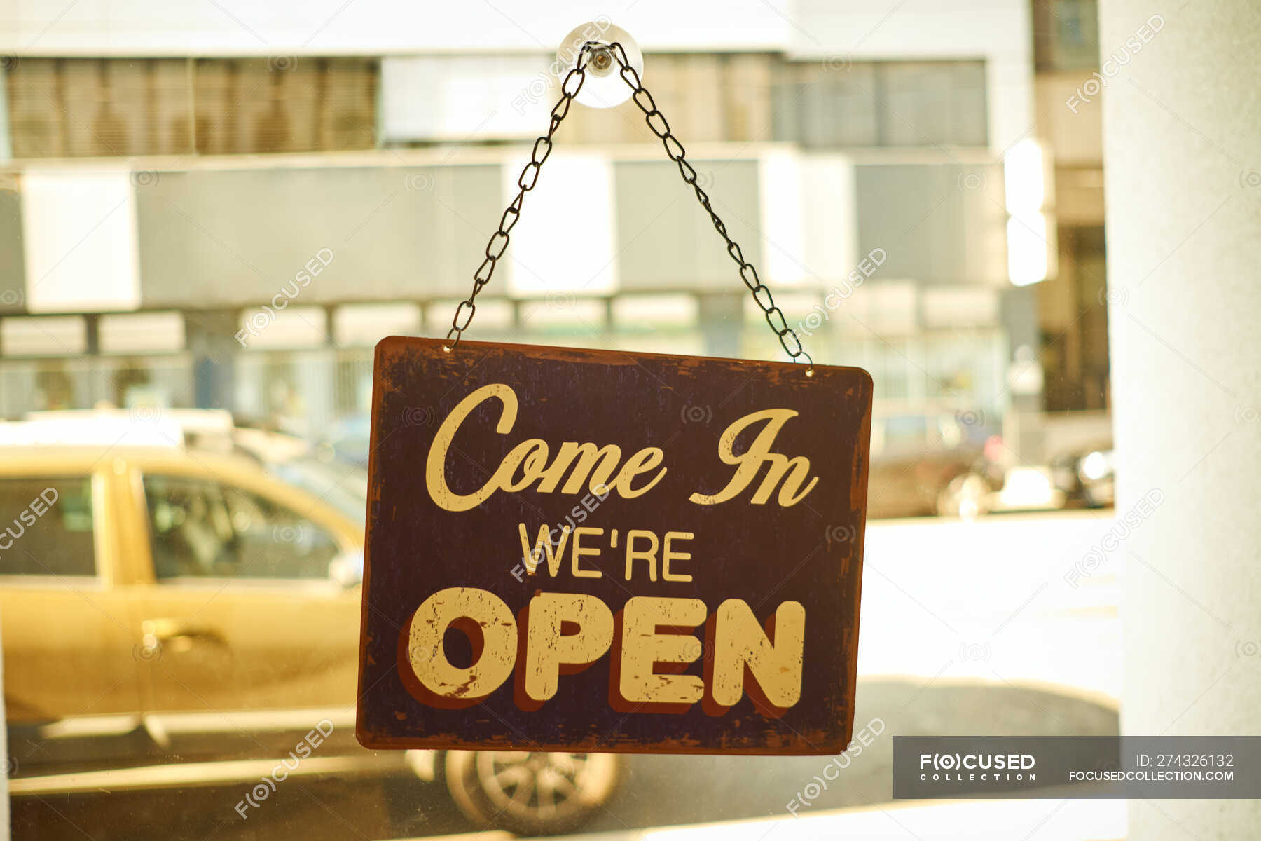 Open sign at small business window with blurred background — shop