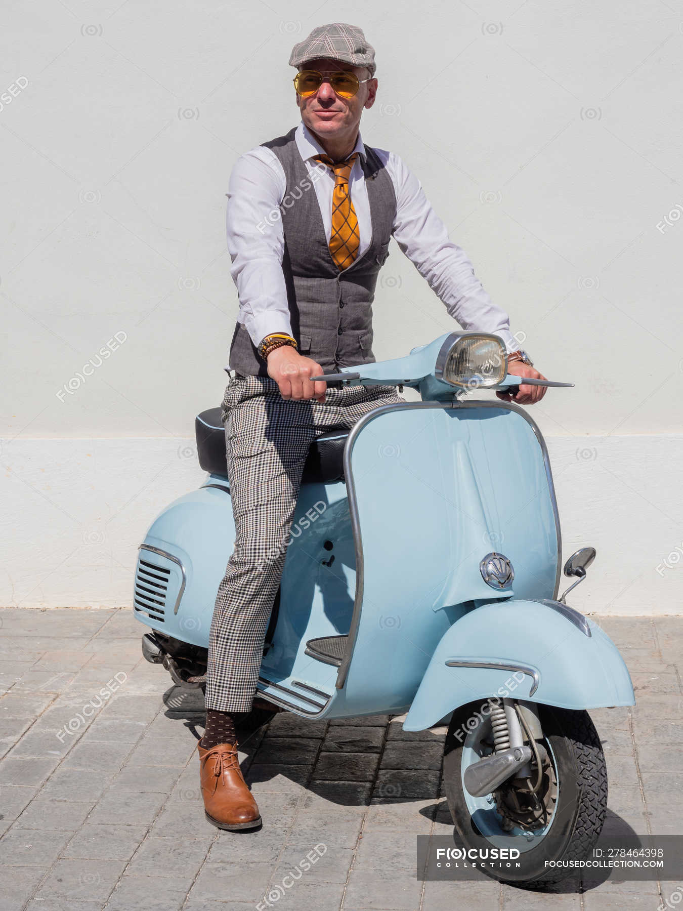 Positive middle-aged hipster in elegant clothes with retro motorbike  looking away in sunny day — sunglasses, caucasian - Stock Photo | #278464398