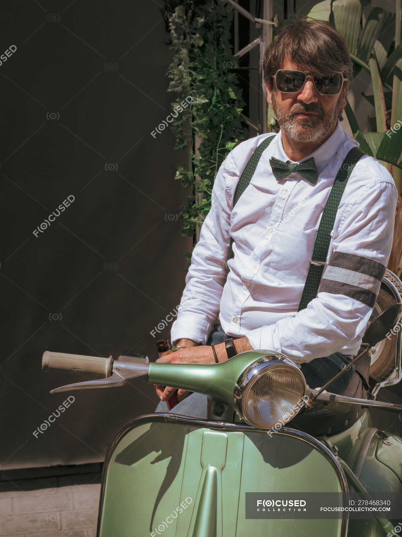 Positive middle-aged hipster in elegant clothes with retro motorbike  looking away in sunny day — travel, cool - Stock Photo | #278468340