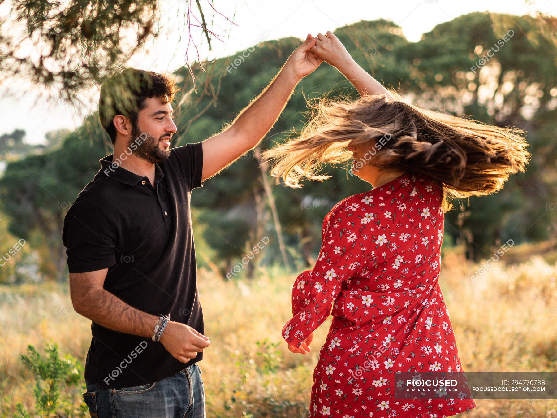 Man and cheerful pregnant wife dancing