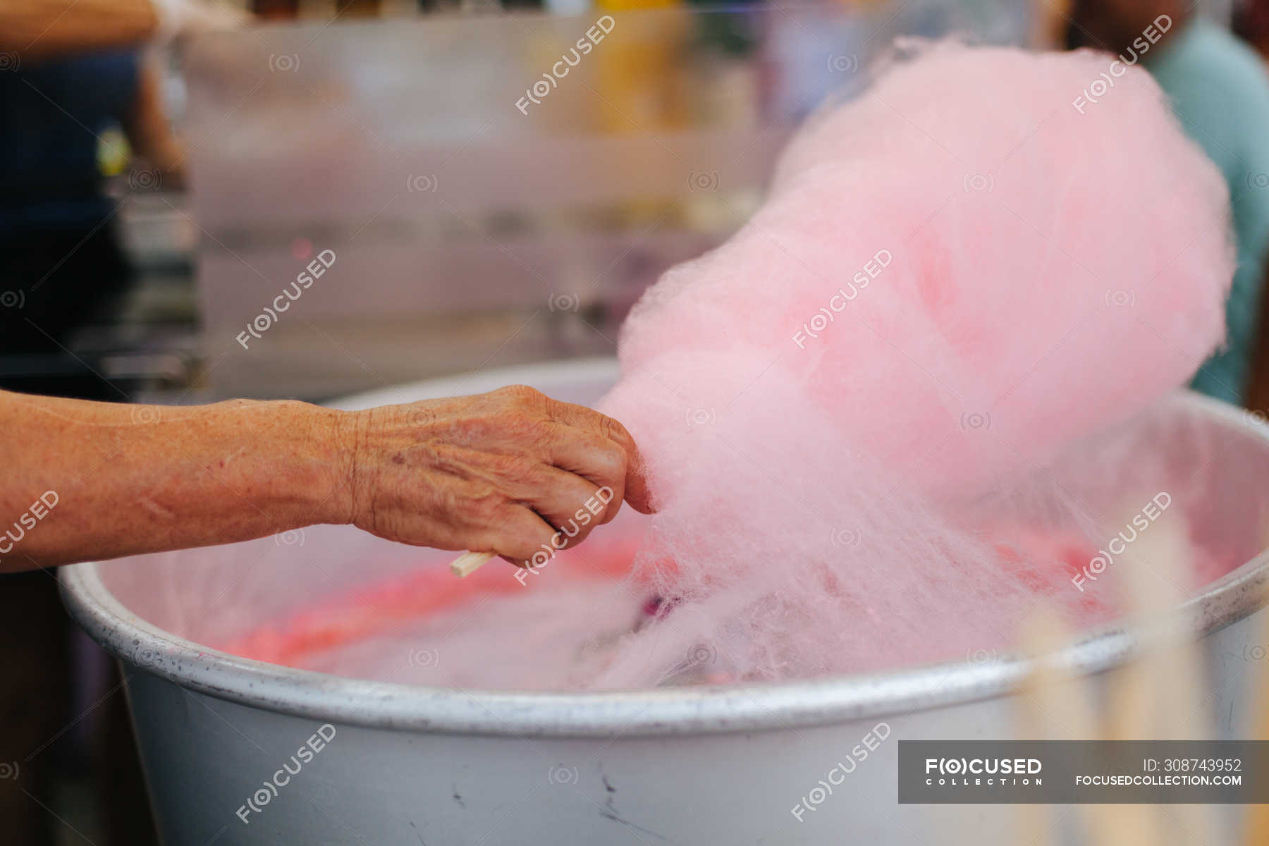 Cropped Image Of Vendor Making Pastel Pink Delicious Cotton Candy On Stick At Fairground Vertical Pleasure Stock Photo