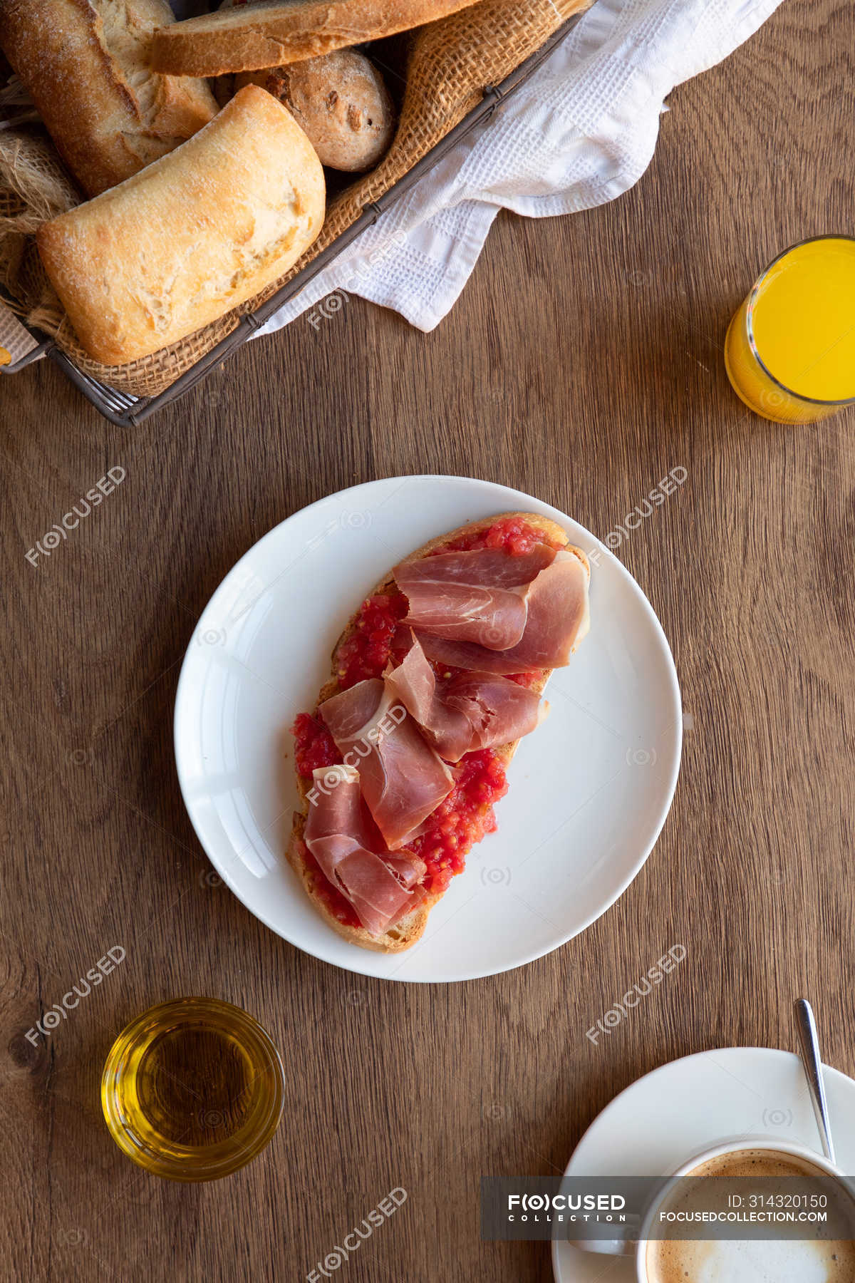 From above of tasty spanish toast with tomato and bacon for breakfast