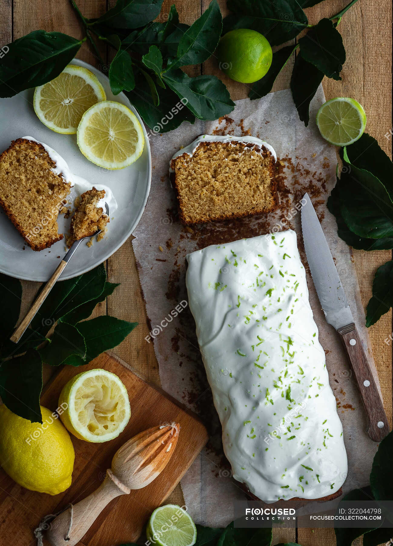 Top view of loaf of delicious pastry with sweet icing placed on wooden