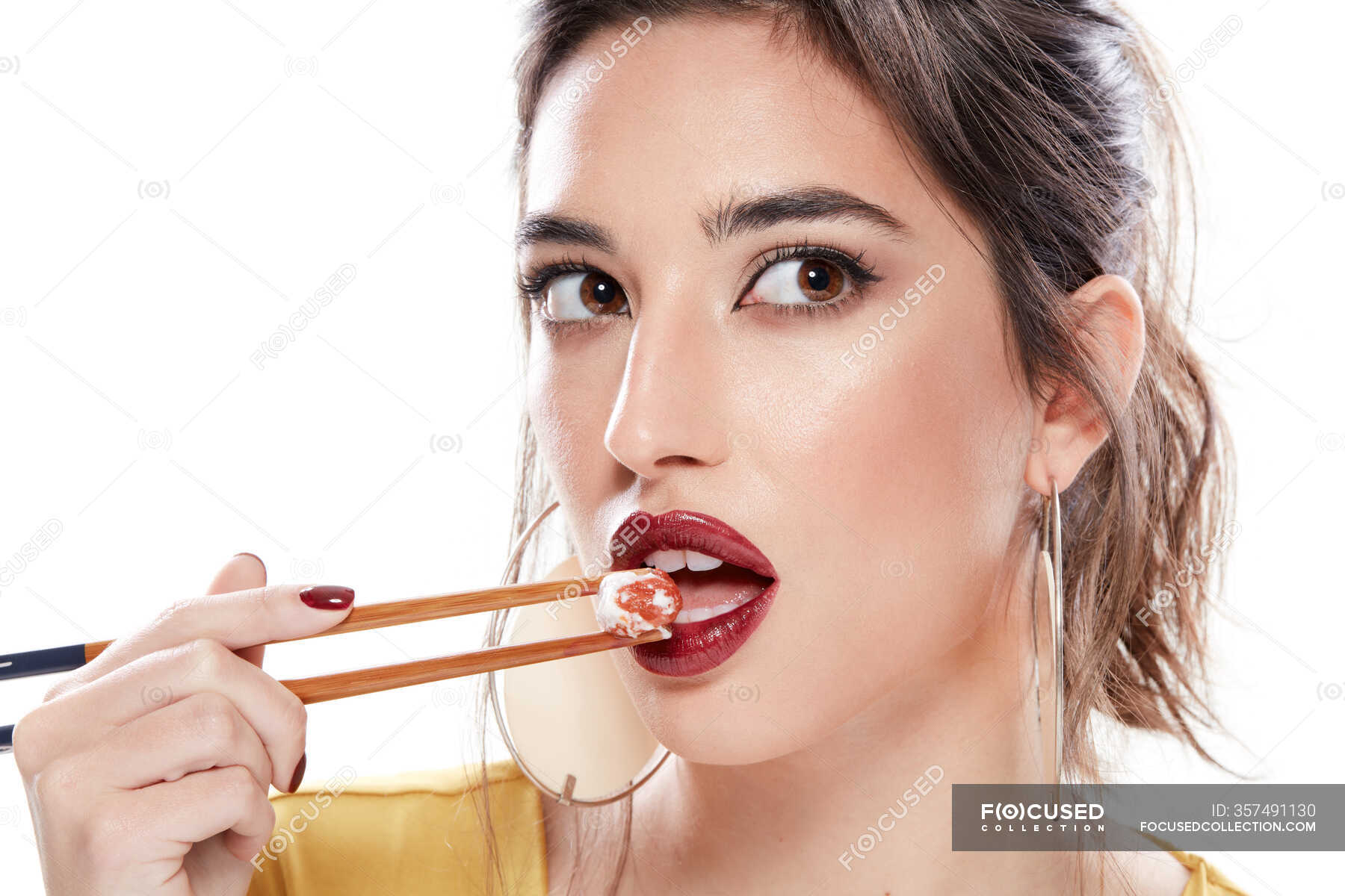 Fancy young woman with red lipstick on opened mouth looking away while
