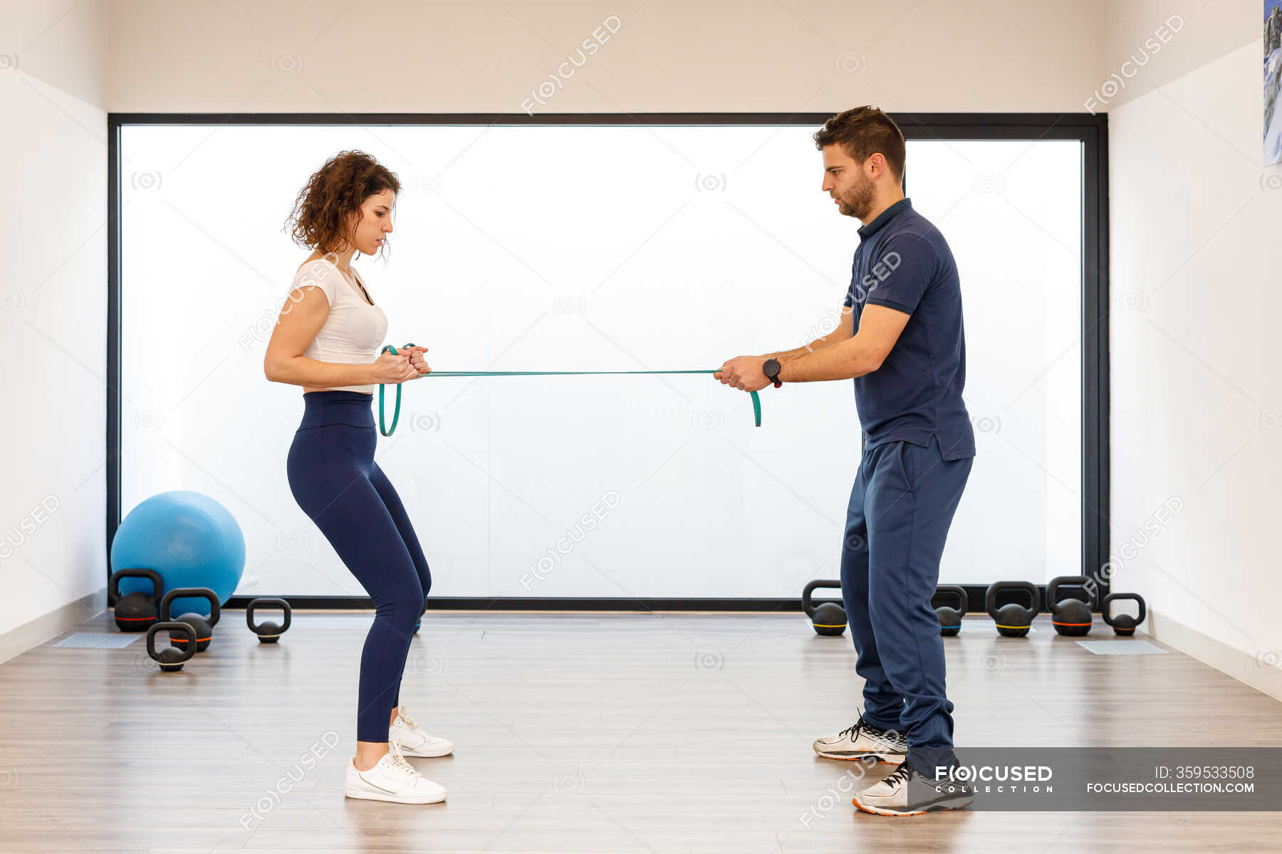 Side view of male and female athletes in active wear standing in front ...