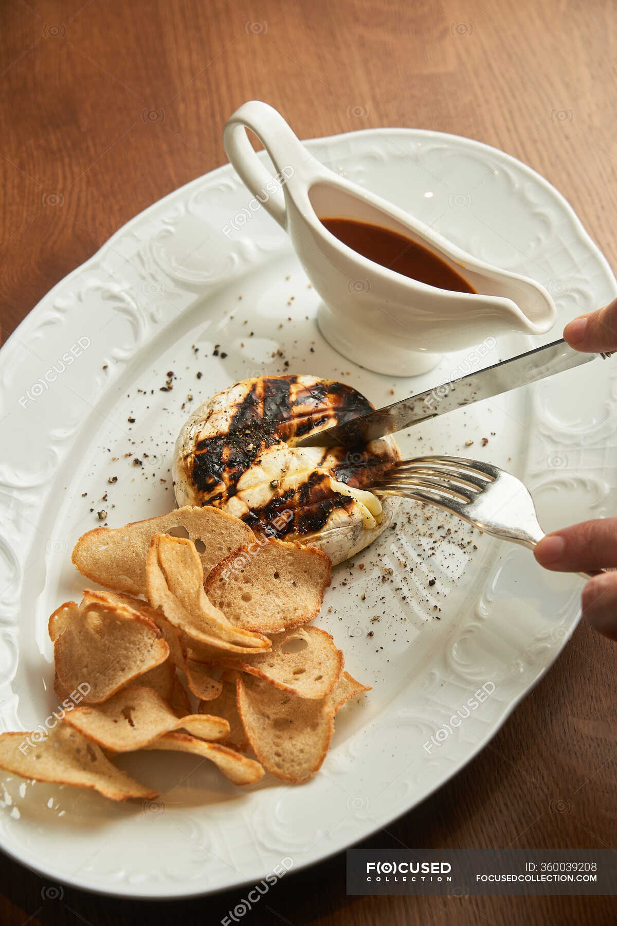 From above unrecognizable person holding cutlery to eat delicious