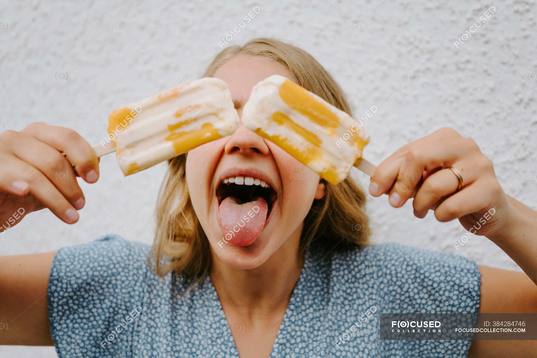 Female Making Funny Grimace With Tongue Out And Covering Eyes With Tasty Ice Lollies On Sticks 5063