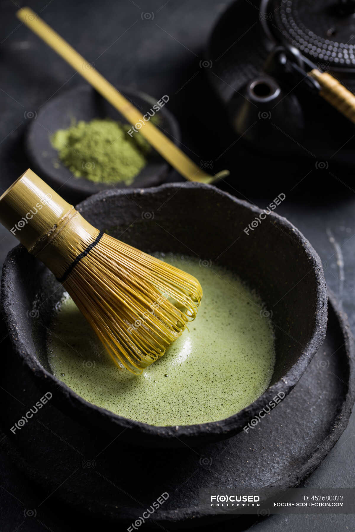 From above of traditional Japanese matcha with tea whisk in stone bowl