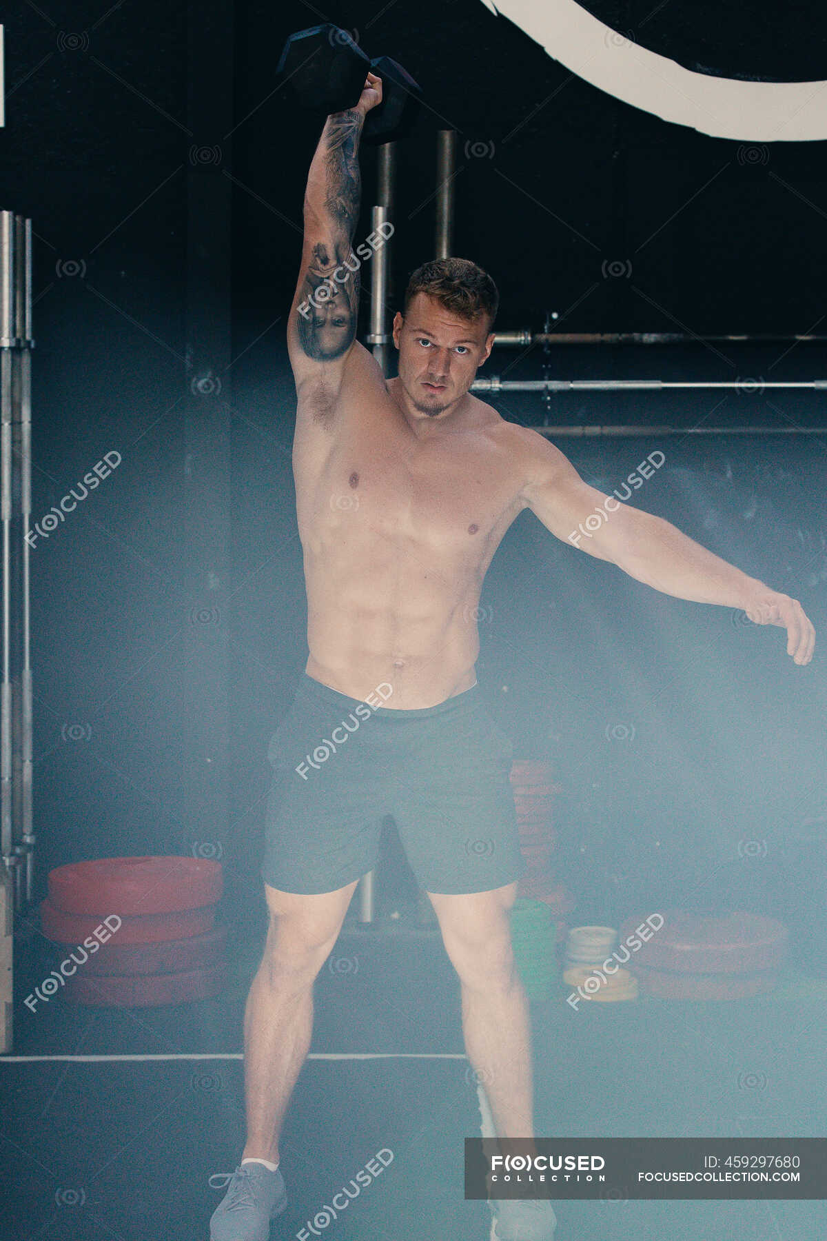 Determined Male Athlete With Naked Torso Doing Kettlebell Snatch Exercise During Functional