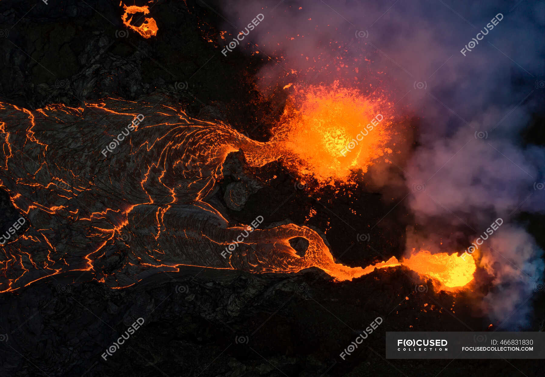From above magma sparks out of the volcano hole and run like rivers of lava over the ground in