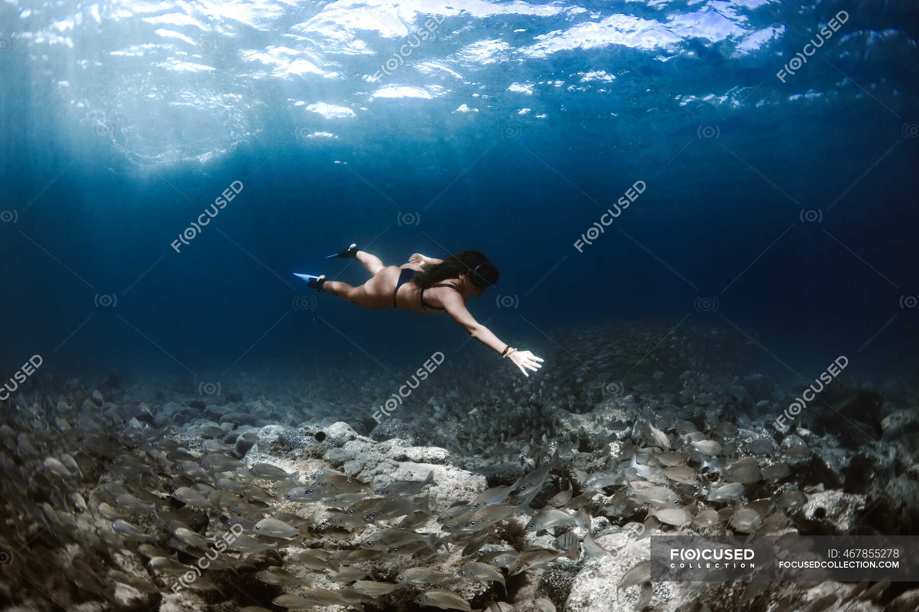 Side view full body of female traveler wearing diving mask swimming ...