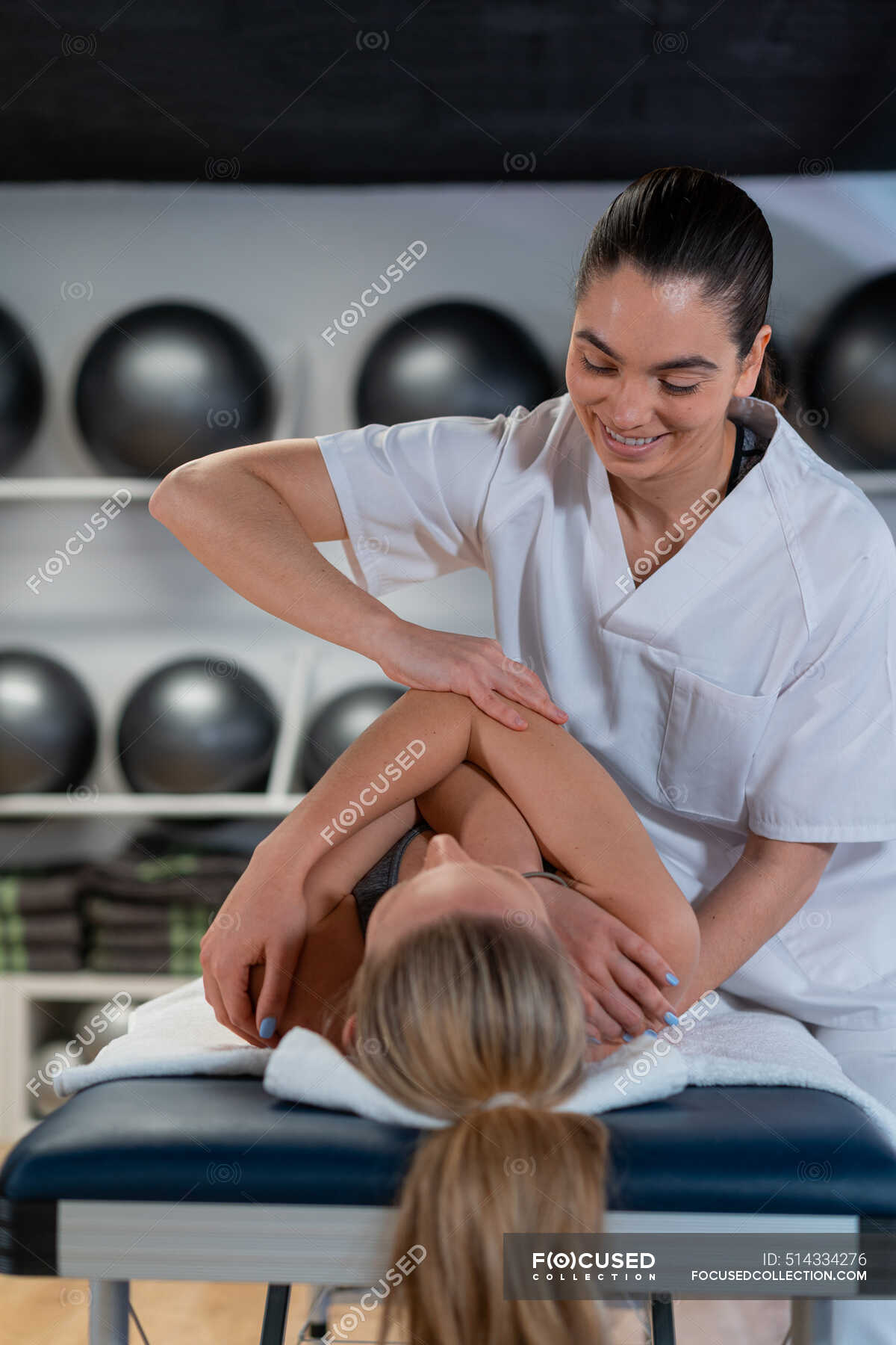 Female Therapist In White Robe Massaging Woman During Osteopathy