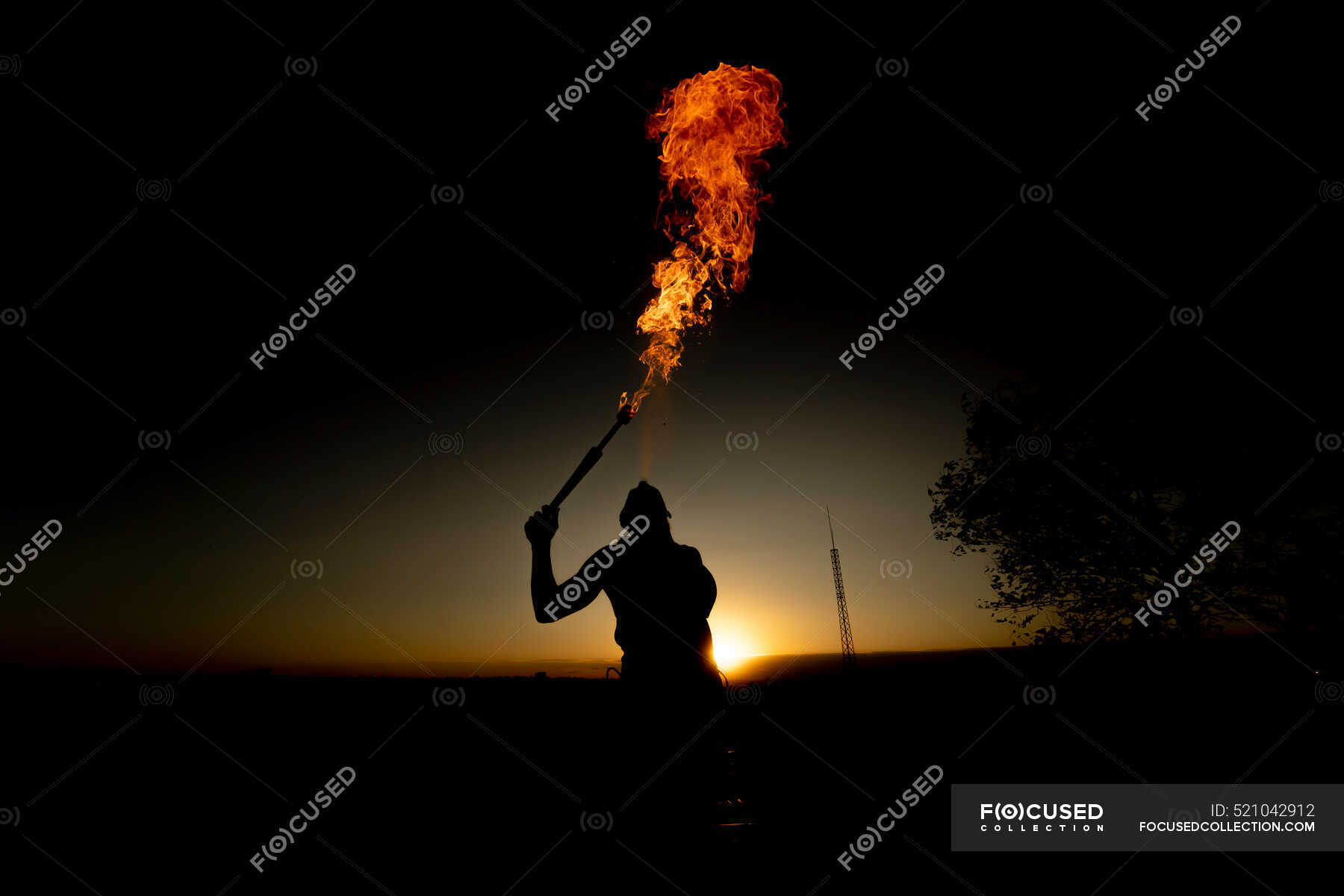 Fire-Eater Woman Performing Spit Fire At Sunset — dangerous, person ...