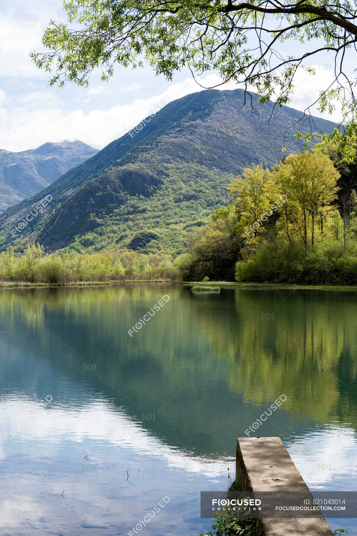 Spectacular scenery of calm pond located in rocky highlands in Pyrenees 