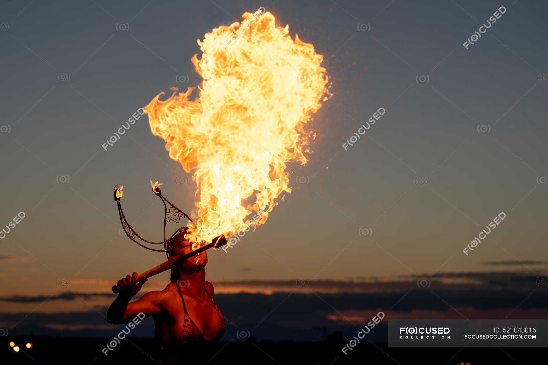 Fire-Eater Woman Performing Spit Fire At Sunset — female, torch - Stock ...