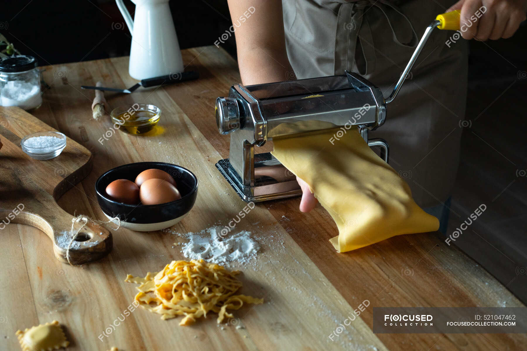 Unrecognizable person preparing raviolis and pasta at home. She is