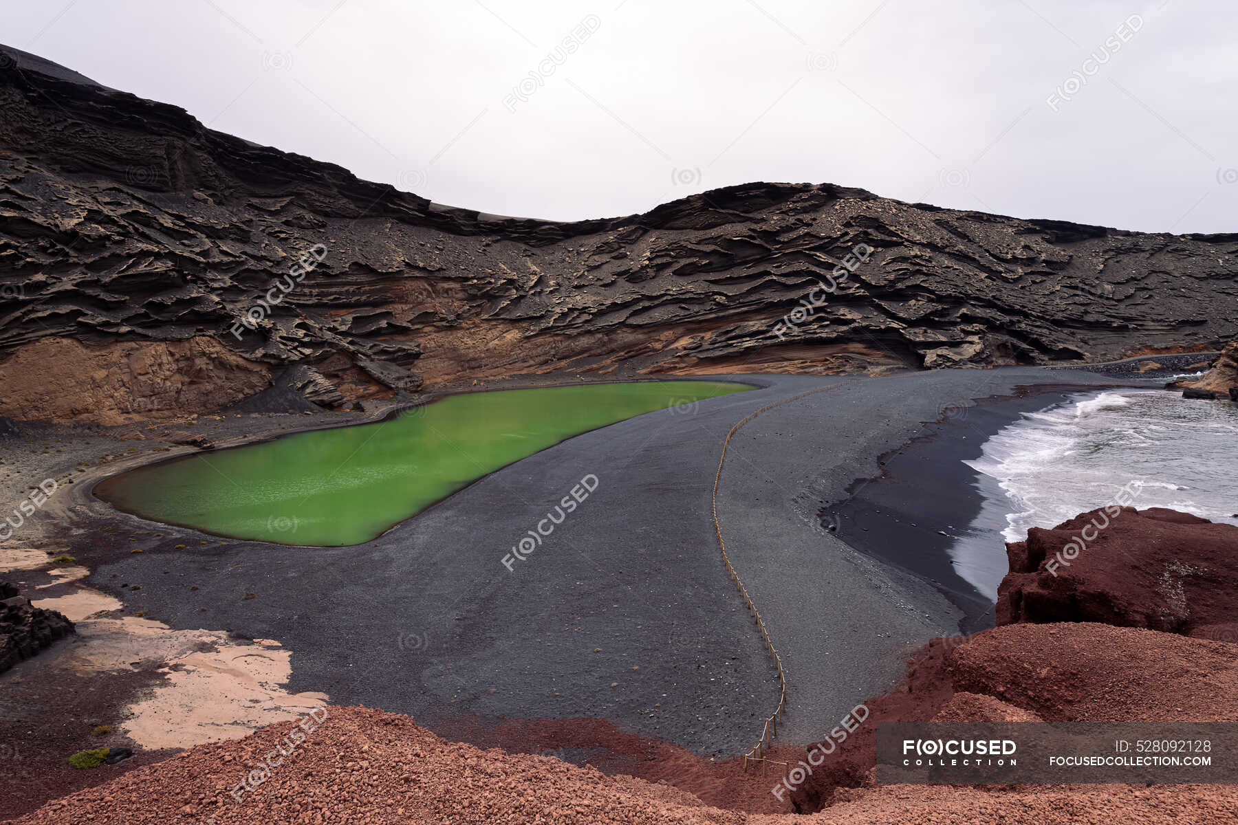 Aerial view of Charco Verde against foamy ocean on highland in Golfo ...