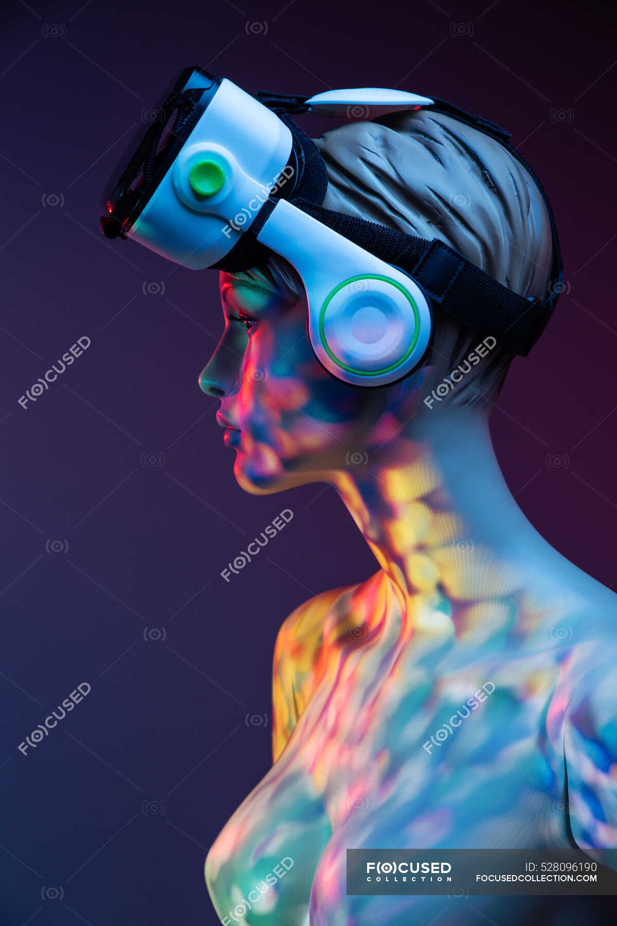 Female mannequin with VR headset standing under bright multicolored
