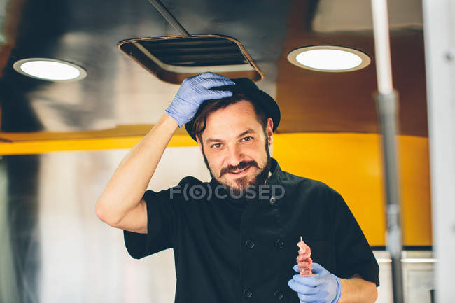 Hombre elegante cocinero en camión de comida - foto de stock